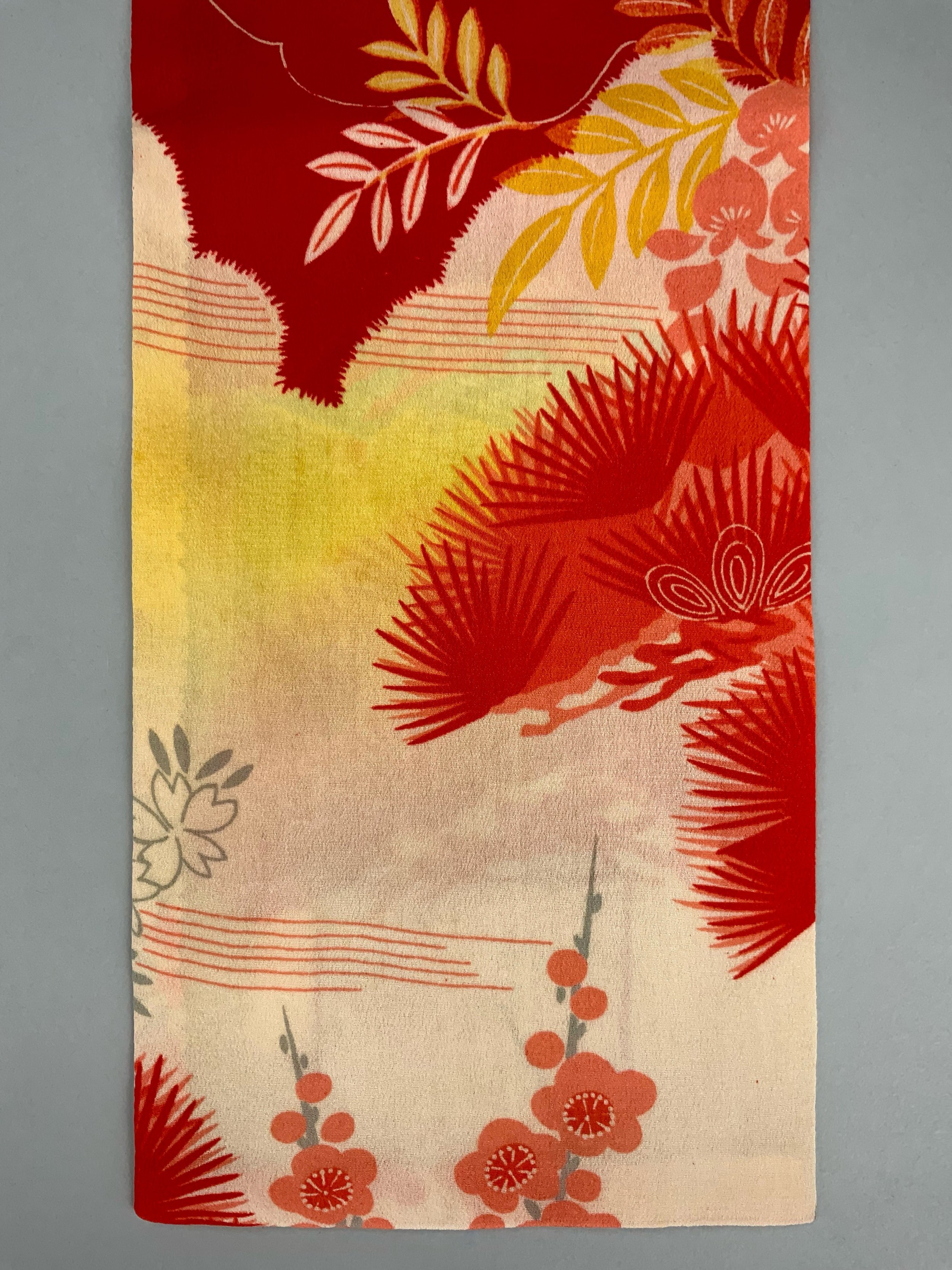 Closeup of vibrant red and yellow scarf with printed blossom design, handmade from repurposed Japanese kimono crepe silk by Kirsty Chivers