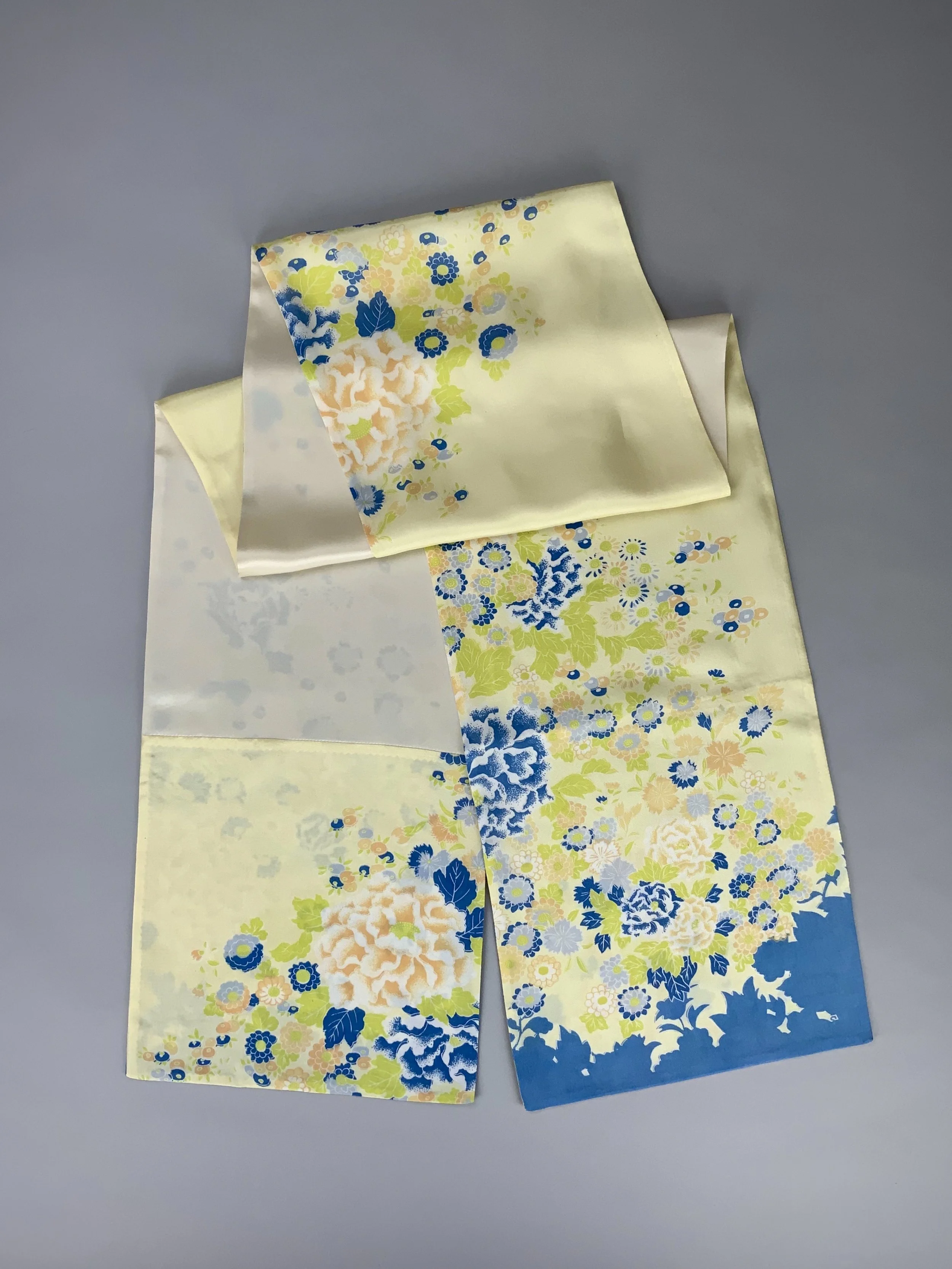 Flatlay of yellow scarf with blossom print handmade from kimono fabric and silk satin by Kirsty Chivers