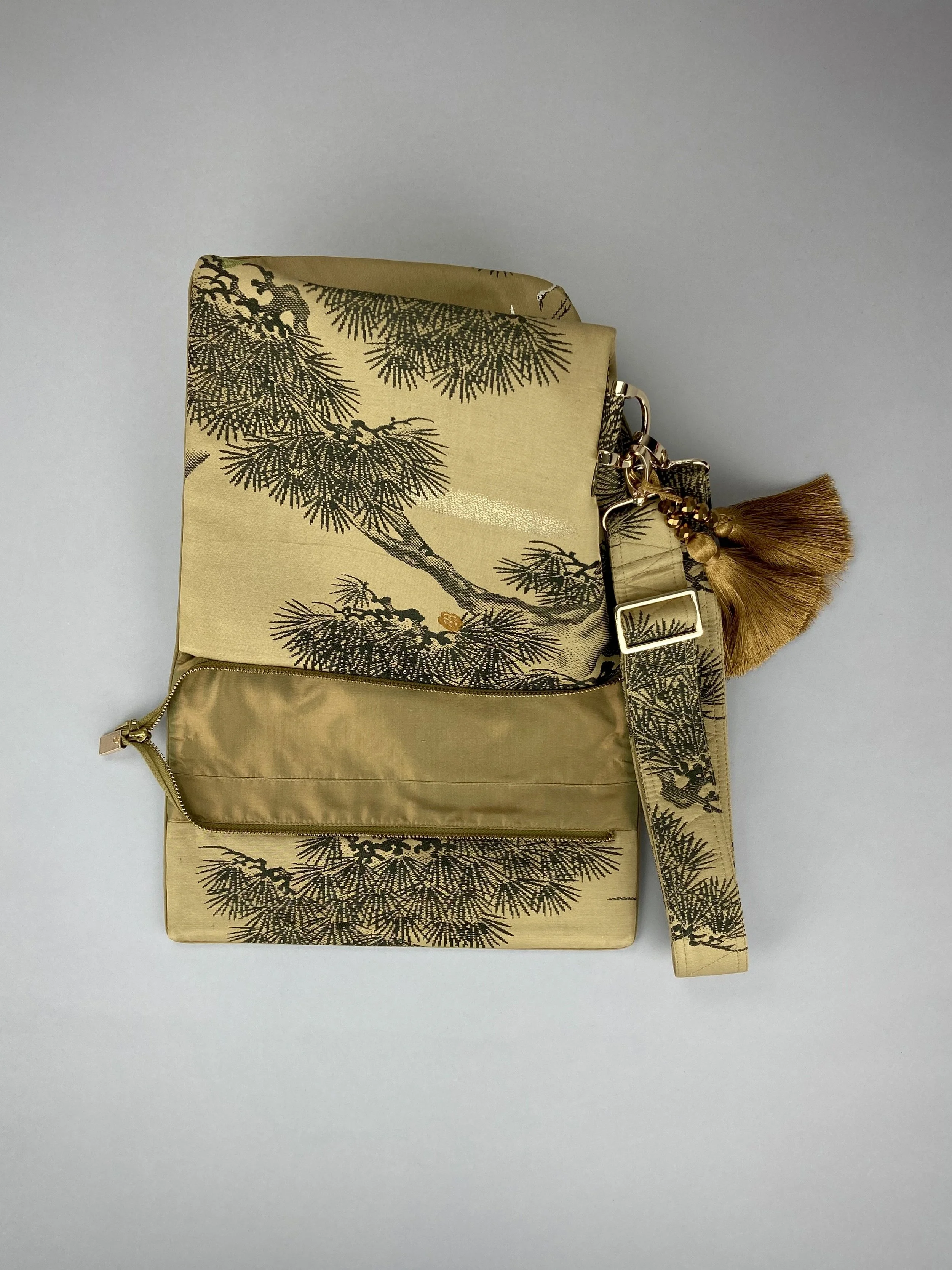 Olive green Matsu pine vintage obi silk shoulder bag with crane design, gold thread detailing and matching fabric tassel charm by Kirsty Chivers