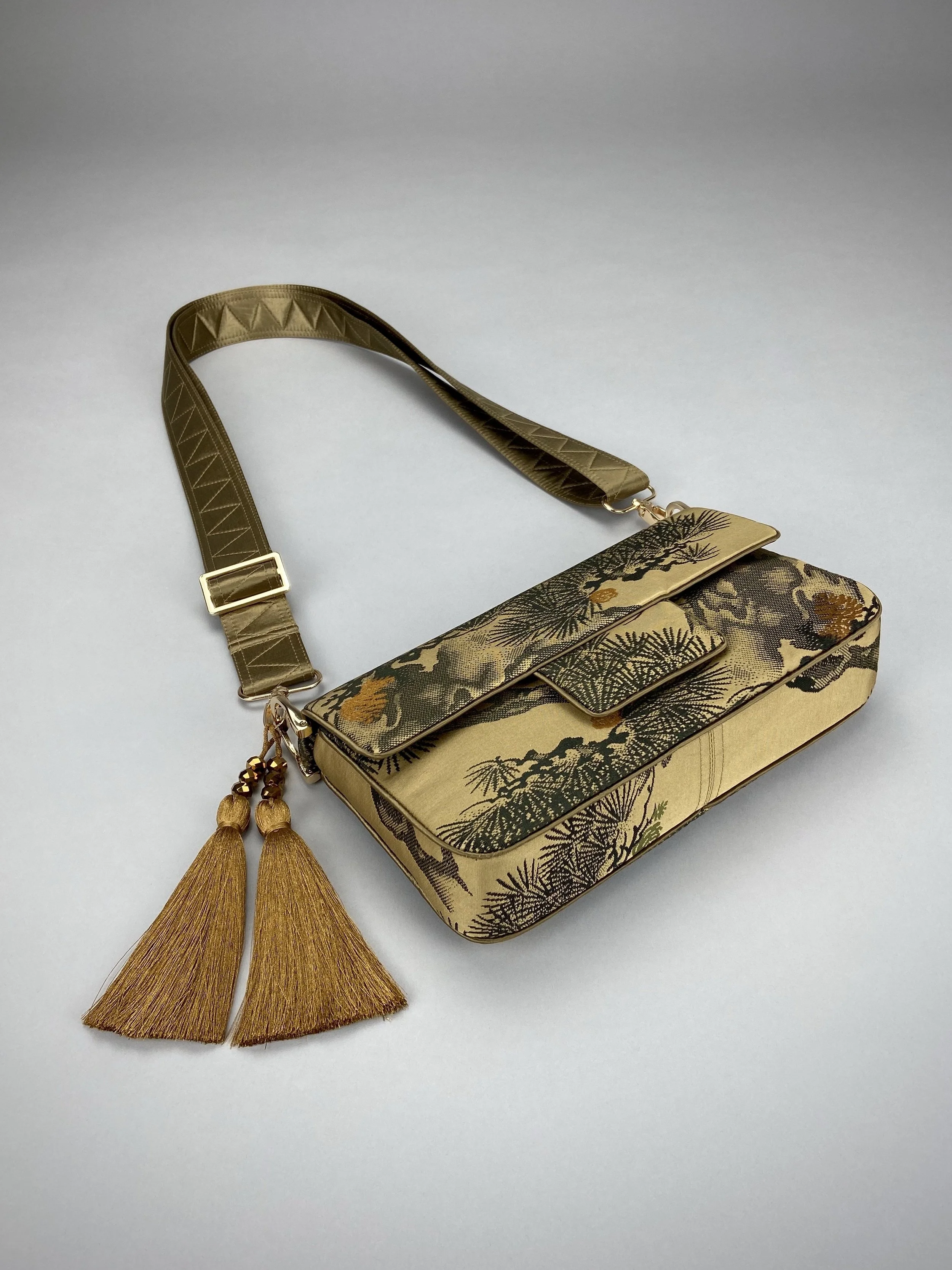 Unique Matsu pine baguette bag, made from vintage Japanese obi silk, with crane design, gold hardware and matching tassel charms by Kirsty Chivers