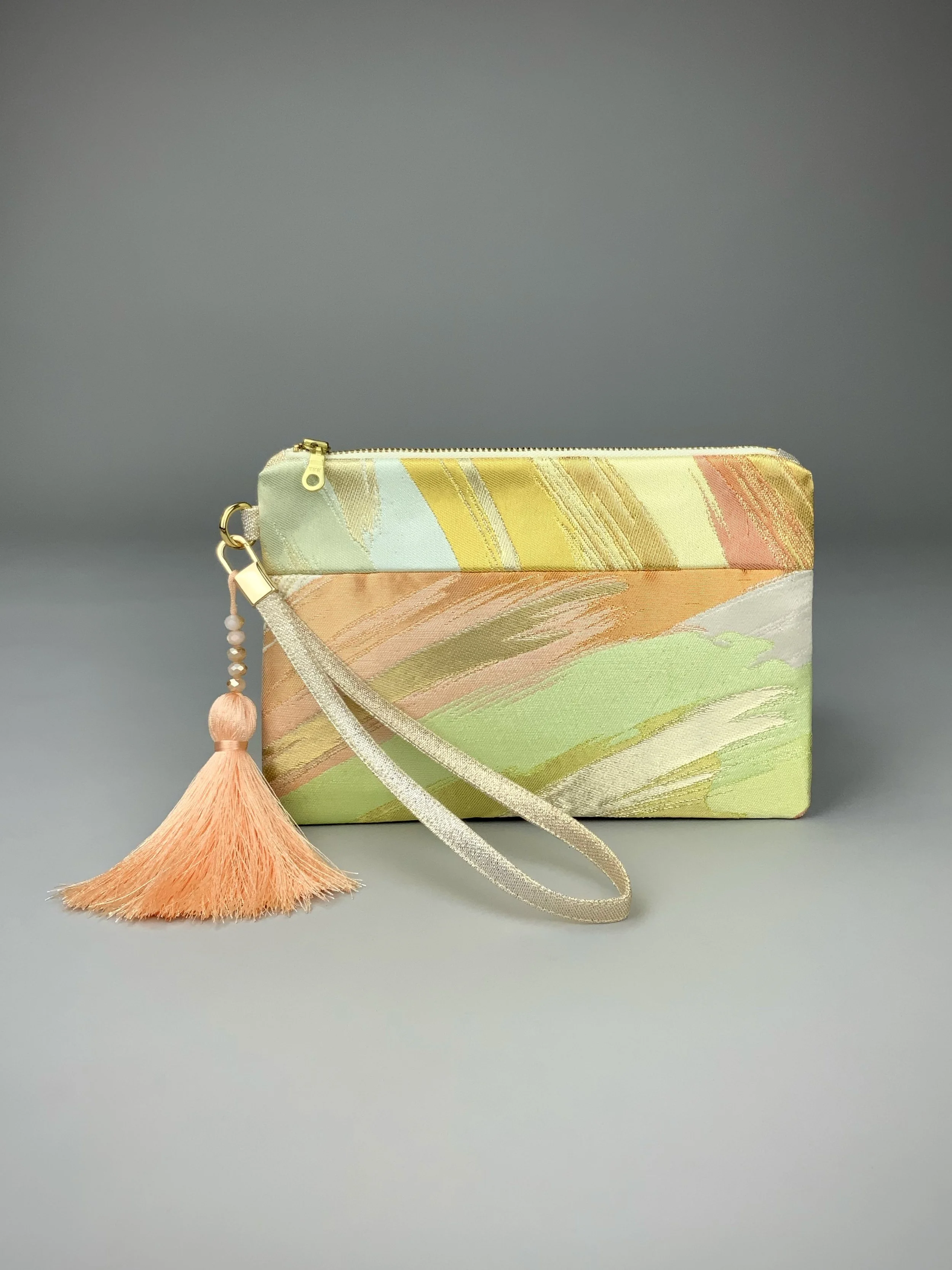 Wristlet purse made from repurposed vintage obi fabric with brushstroke pastel design and gold-silver threads