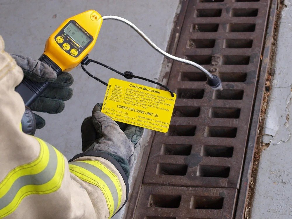 gas monitor reference tag in use clipped to detector during firefighter training or field use