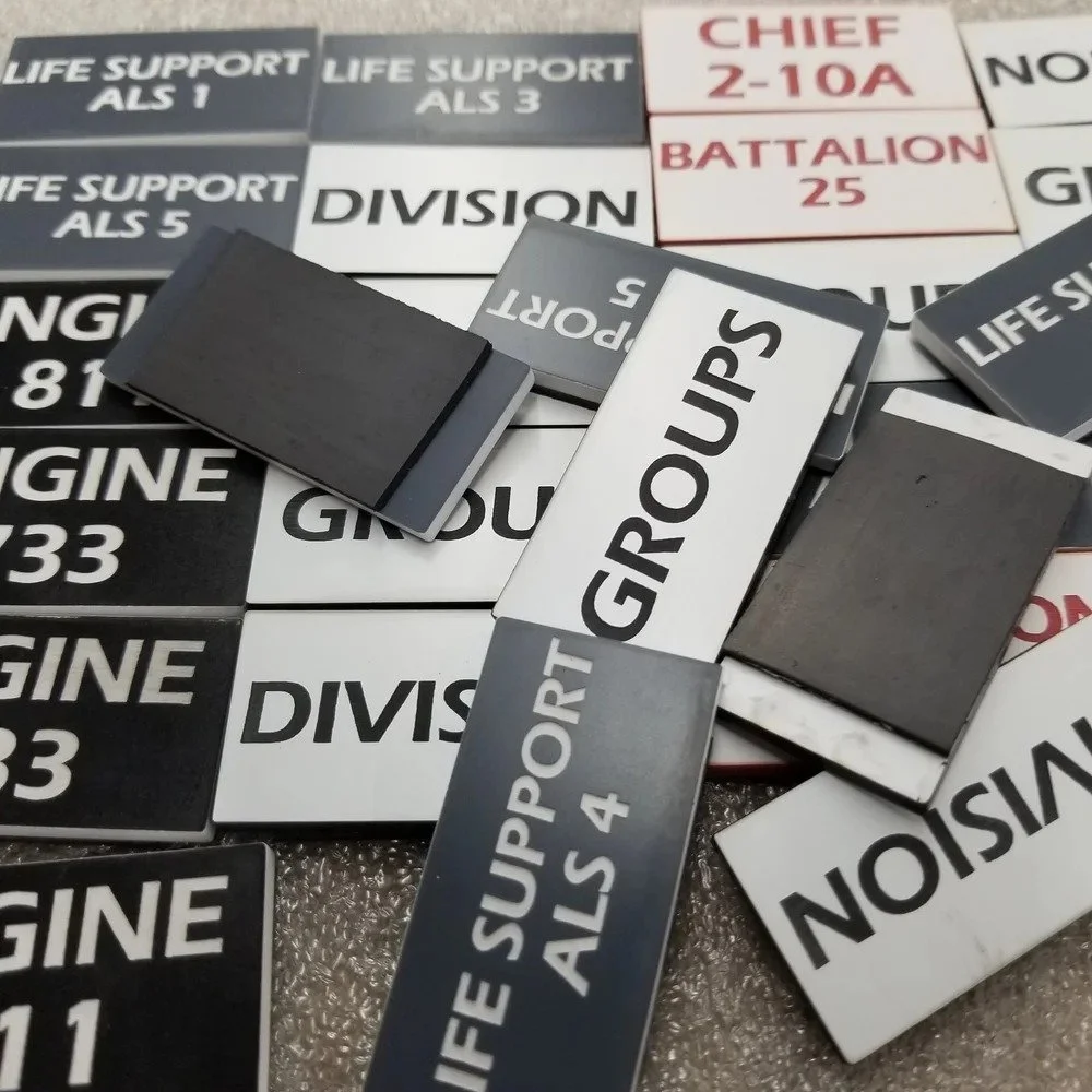 Magnetic tags for fire command board showing division and group labels for incident management organization