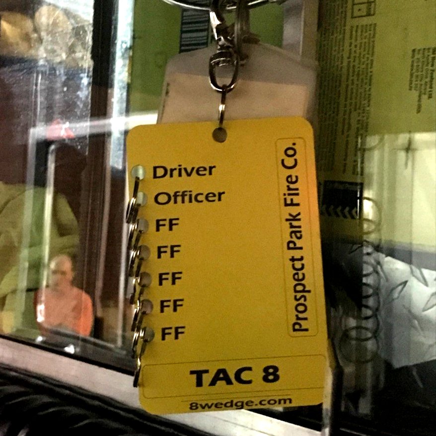 Fire apparatus accountability tags mounted inside command board showing crew positions and TAC unit assignments