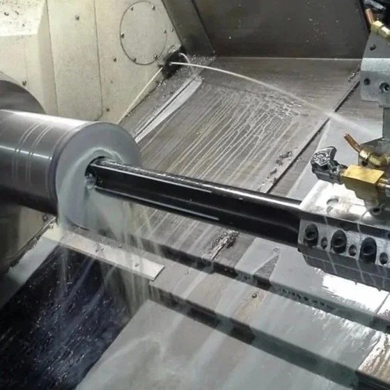 cnc lathe drilling large diameter hole in steel round bar during precision machining