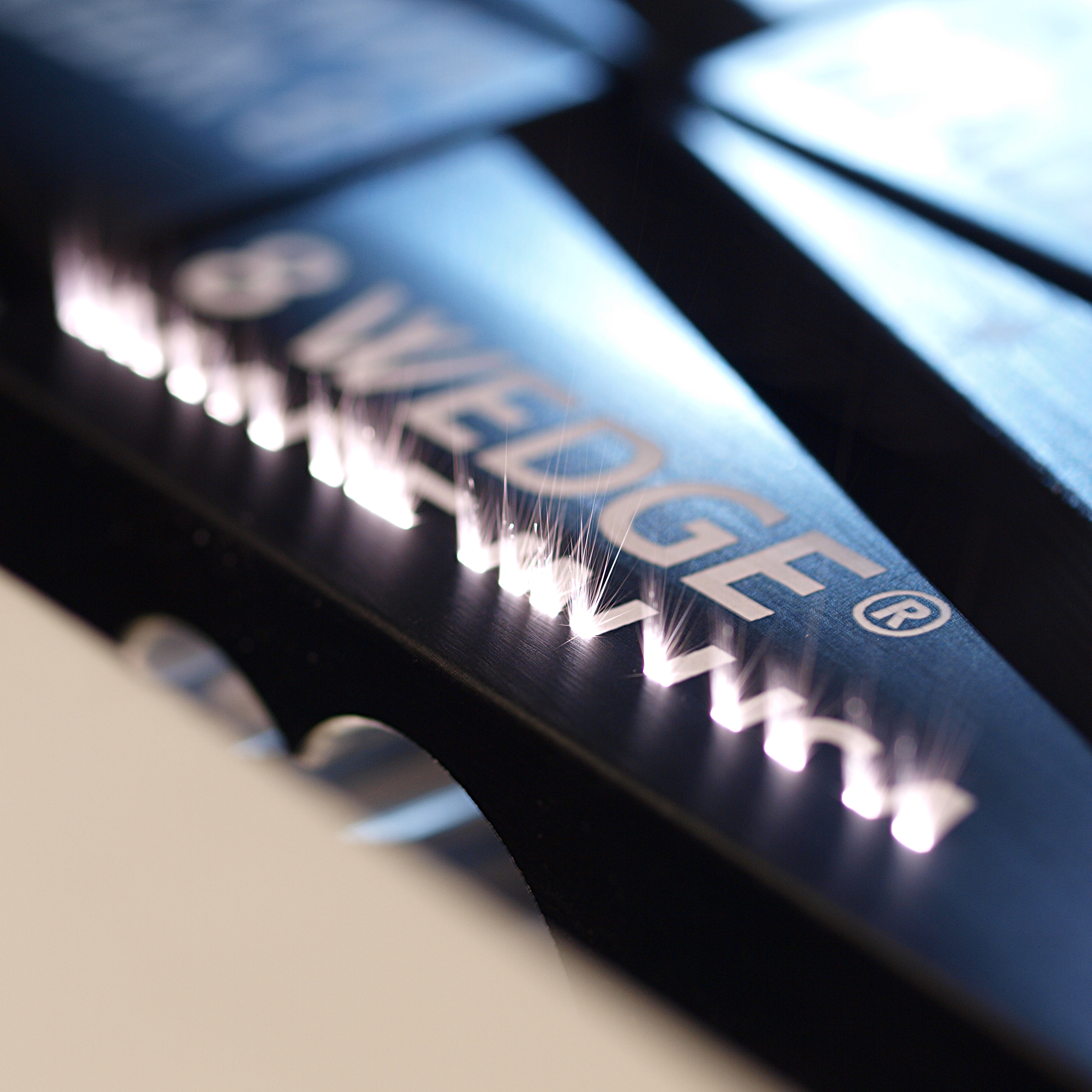 Close-up of laser engraved 8 WEDGE firefighter forcible entry wedge tool showing precision aluminum engraving detail