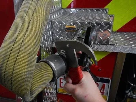TUF 8 firefighter multi tool used on hose coupling during fireground operations