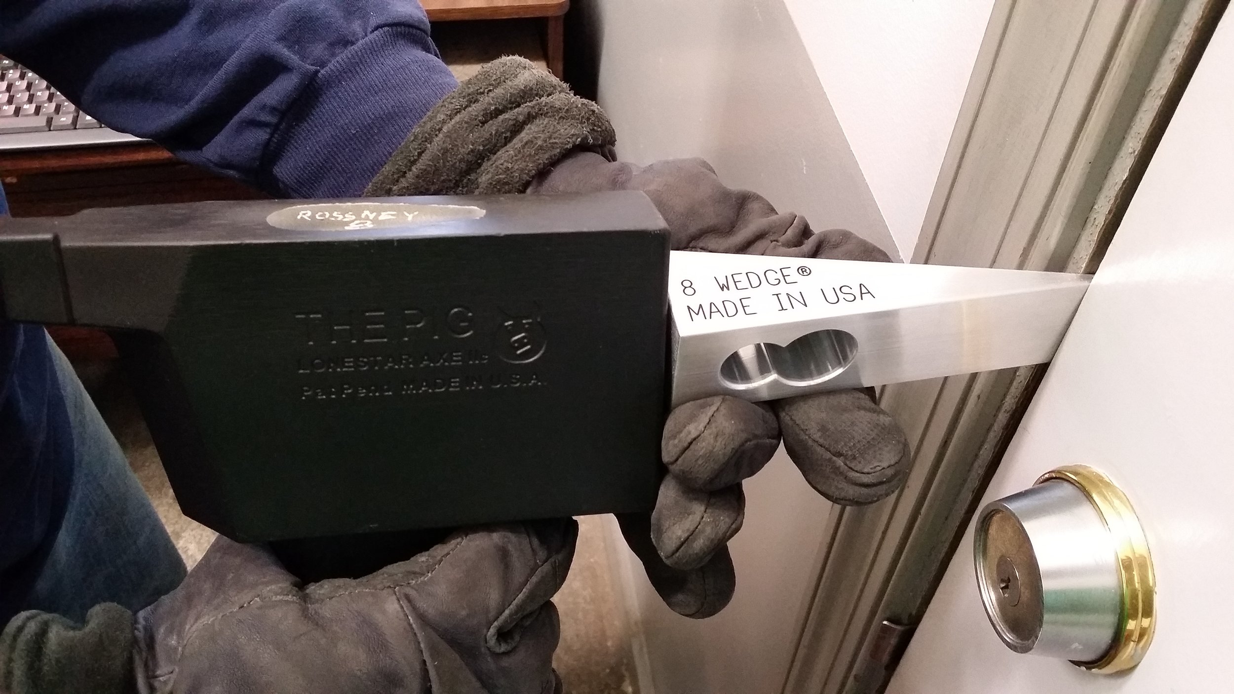 8 WEDGE firefighter door wedge tool in use creating a door gap during forcible entry operation