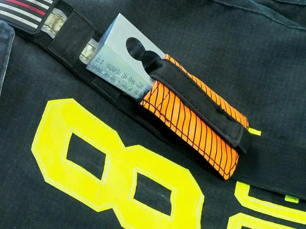 STRP tool pouch mounted on turnout gear holding 8 WEDGE for quick access during operations