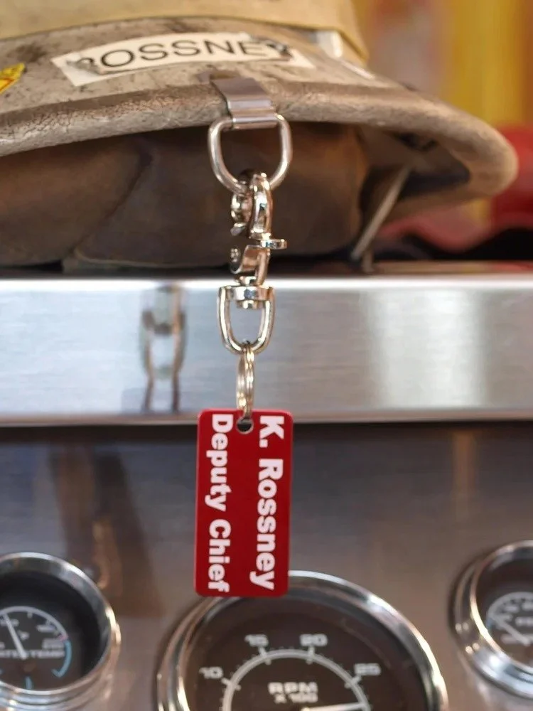 Firefighter accountability tag clipped to helmet showing real-world use for personnel identification on scene