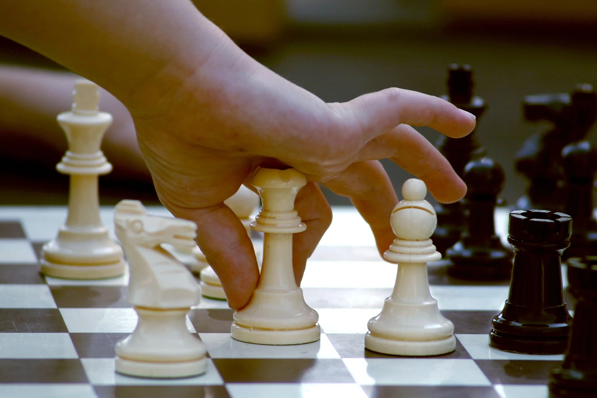 child-hand-on-chess-piece.jpg
