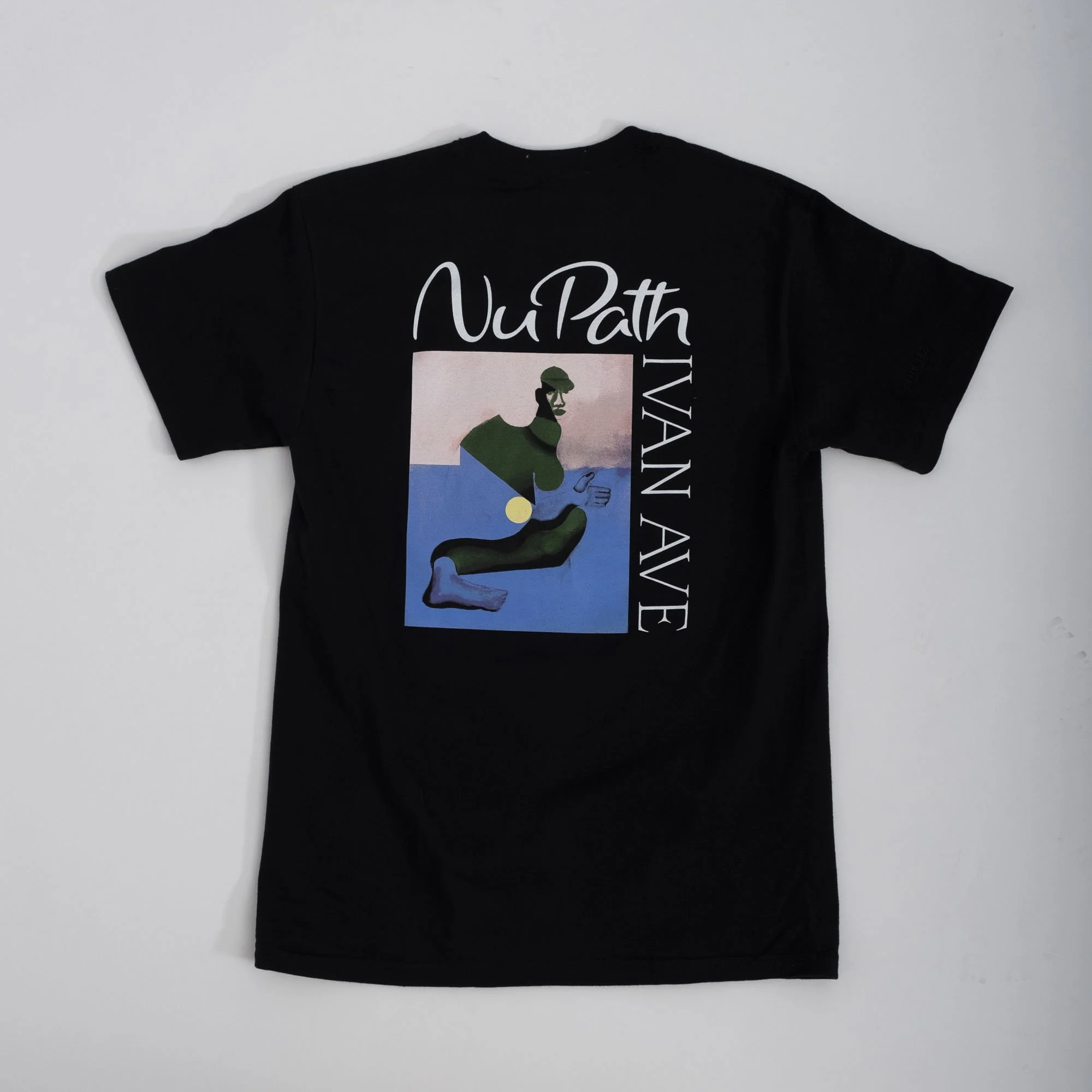 Black T-shirt with colorful abstract art and text reading 'NuPath' and 'Ivan Ave'.