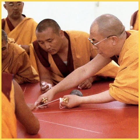 H.H. the Dalai Lama lays a mandala chalk line, evenly, level and unconfused