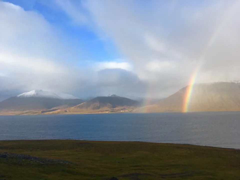 The whale was submerged just below the surface, between these two rainbows.
