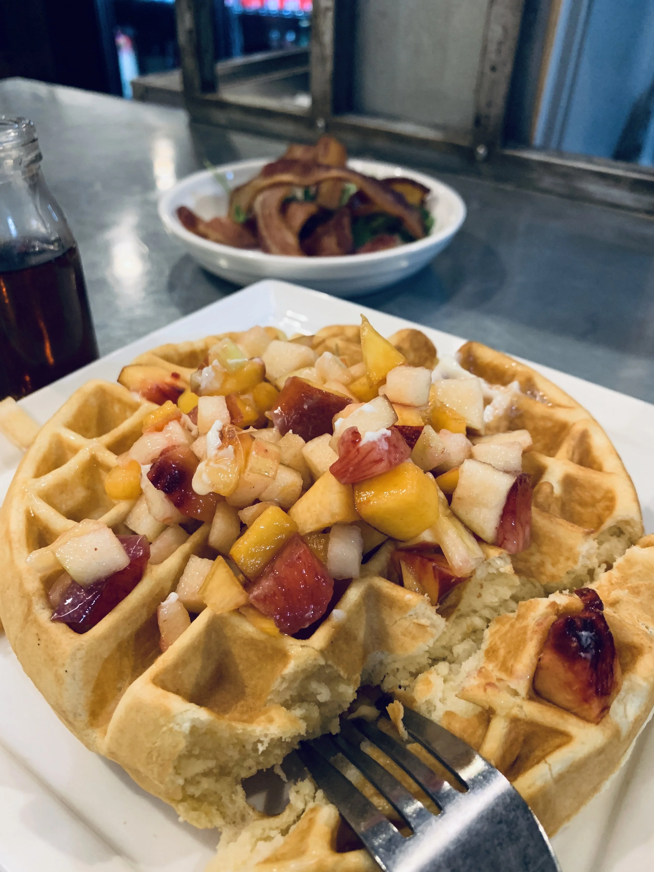 Left: Waffle - buttermilk batter waffle, diced fruit, whipped butter, warm syrup $11 Side: Bacon $6.00 Drink: Orange Juice