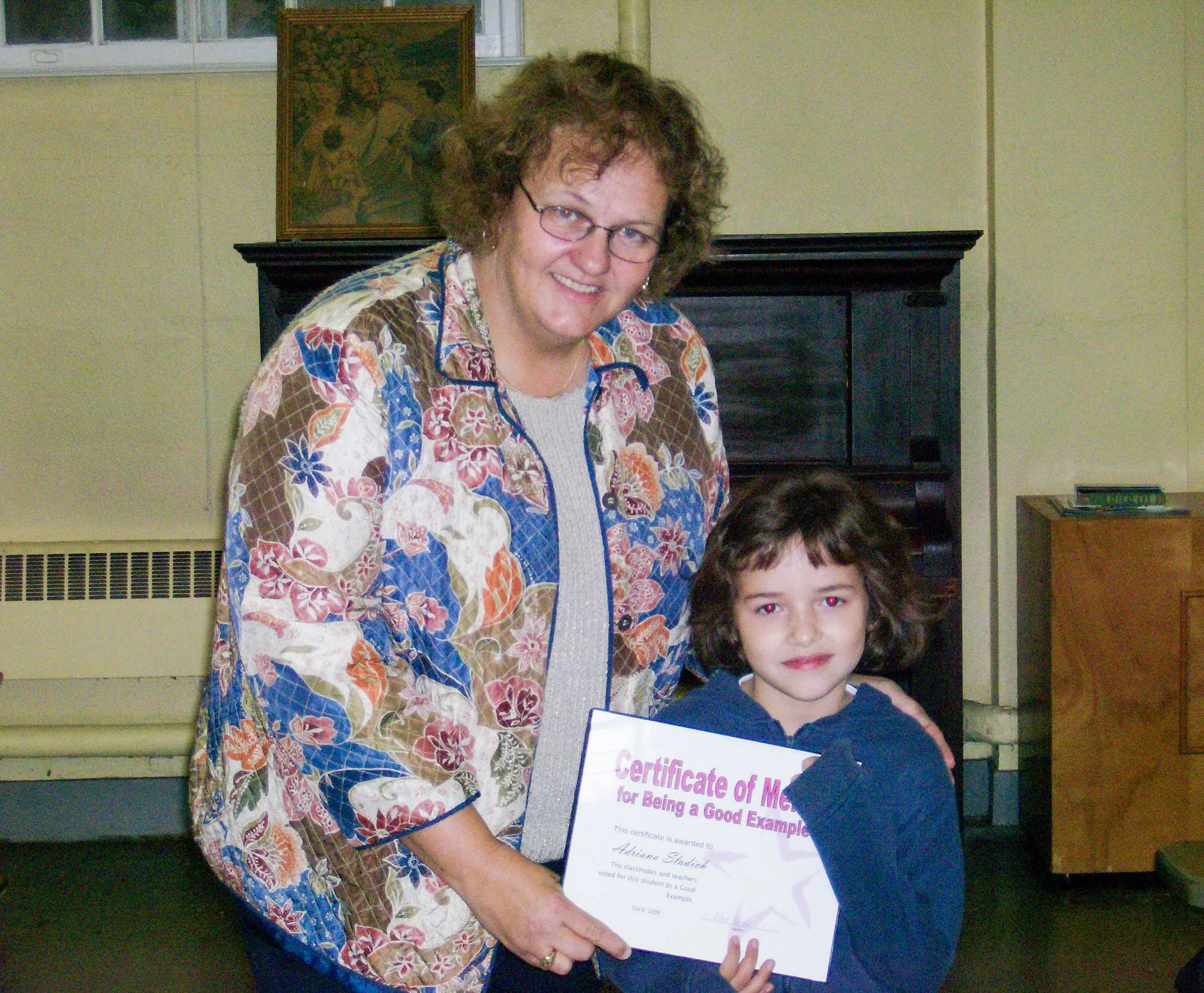 Jeanne Carroll, co-founder of New Hope School, posing with one of the first students of New Hope.