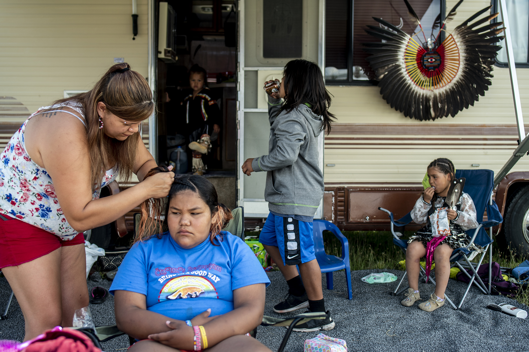  Patricia Hendrickx, left, helps Jessi James, middle, with her hair before the performance of the Snake Dance during the Arlee Celebration, Thursday, July 4, 2019 in Arlee, Montana. 