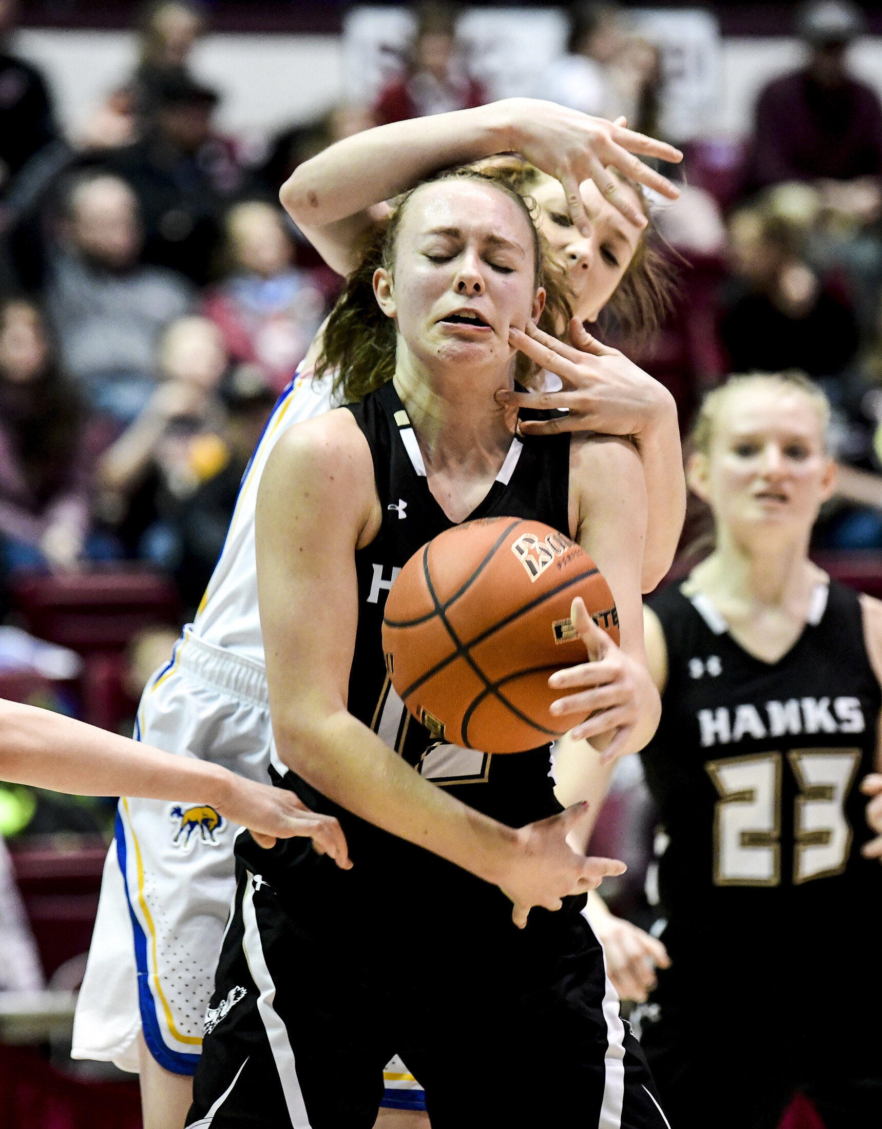  Seeley-Swan's Sariah Maughan, front, fumbles with the ball as Melstone's Kelsey Thurston, rear, reaches over her back during their Class C girls state quarterfinal basketball game at Dahlberg Arena, March 12, 2020 in Missoula, Mont. The Broncs defea