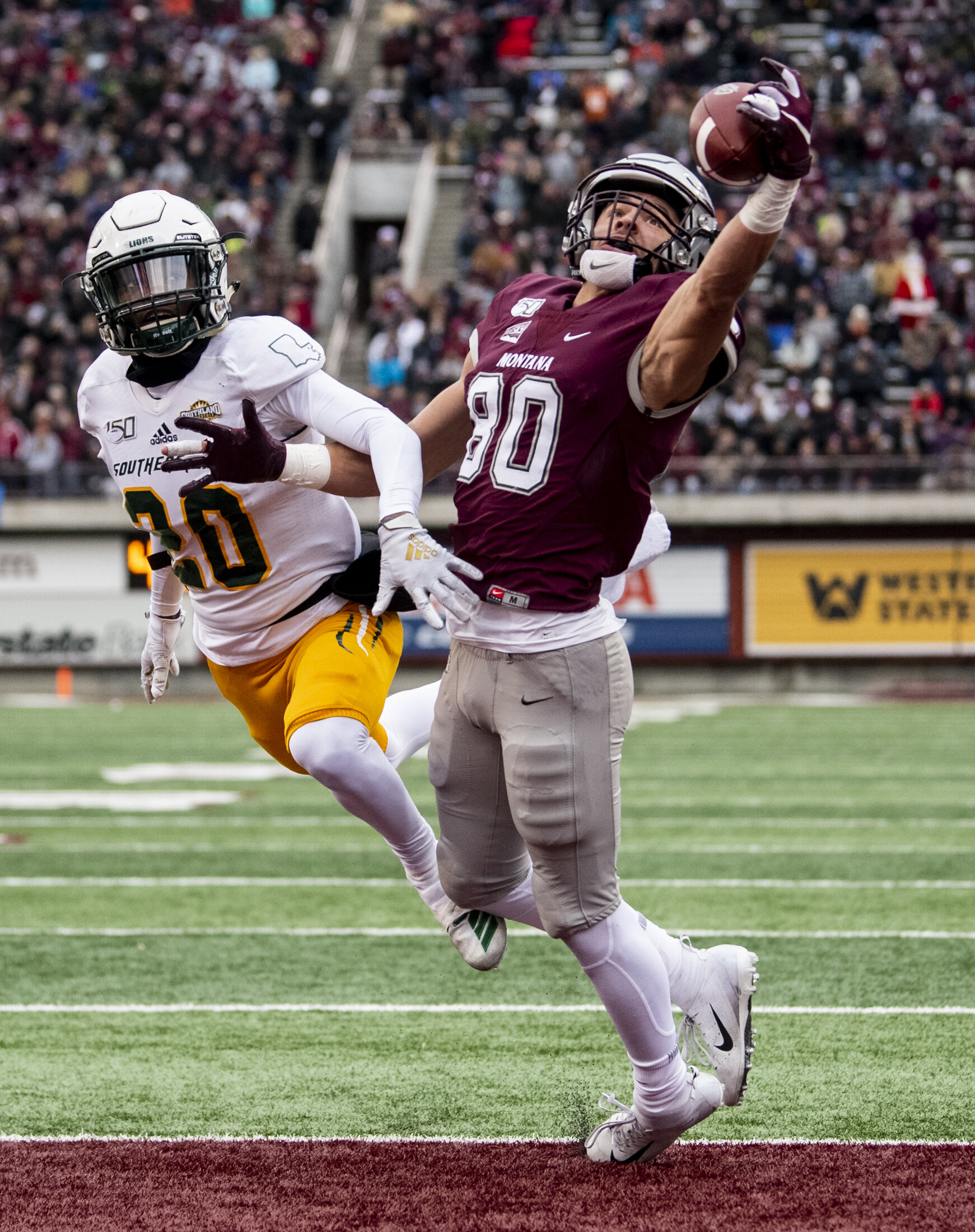  Montana's Mitch Roberts (80) tries to a catch a pass in the end zone ahead of Southeastern Louisiana's Dontrell Smith (20) during their game at Washington-Grizzly Stadium, Dec. 7, 2019 in Missoula, Mont. 