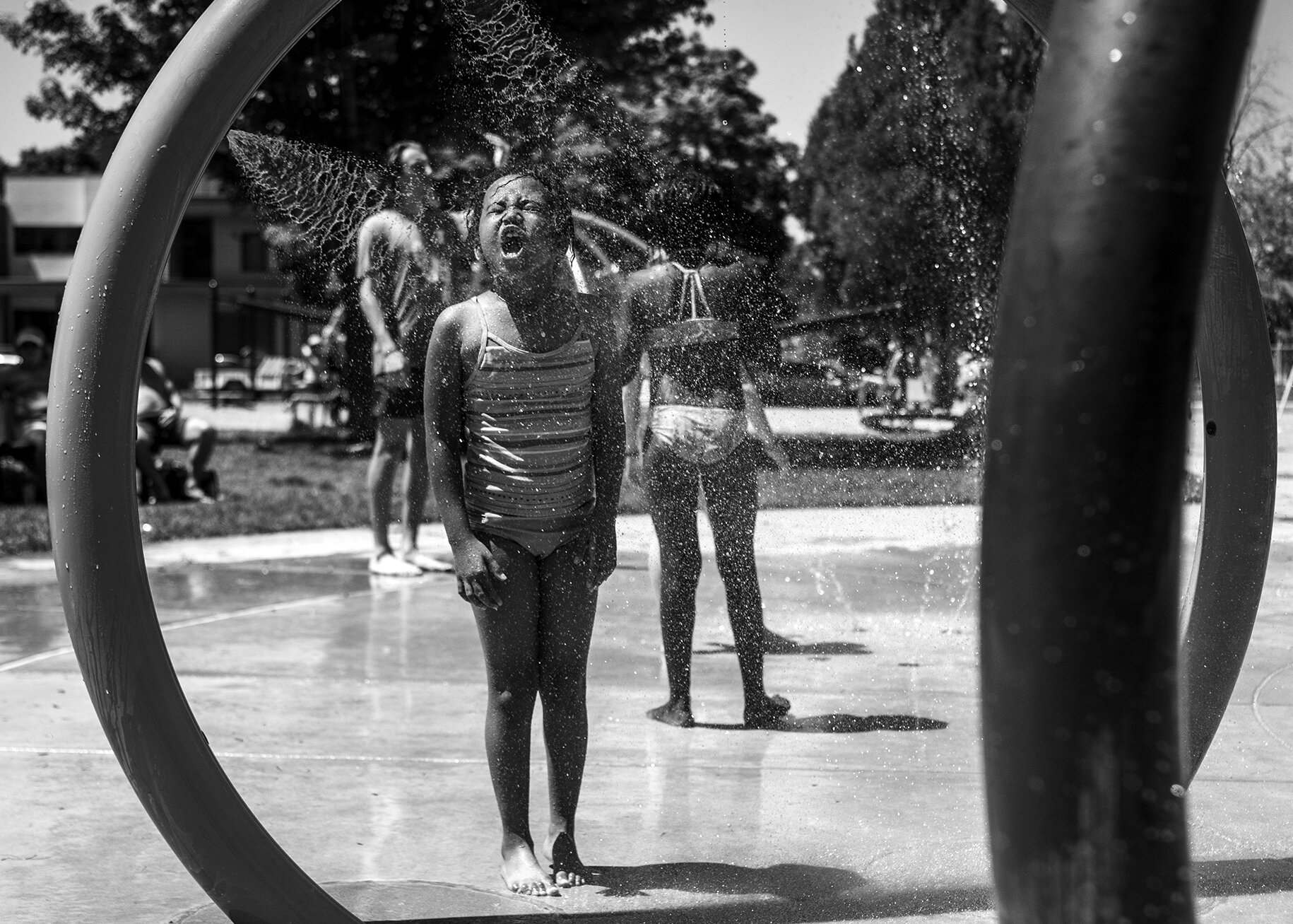  Children cool off in a splash pad at Bonner Park in Missoula in June 2020 as temperatures soar into the low 100s.  