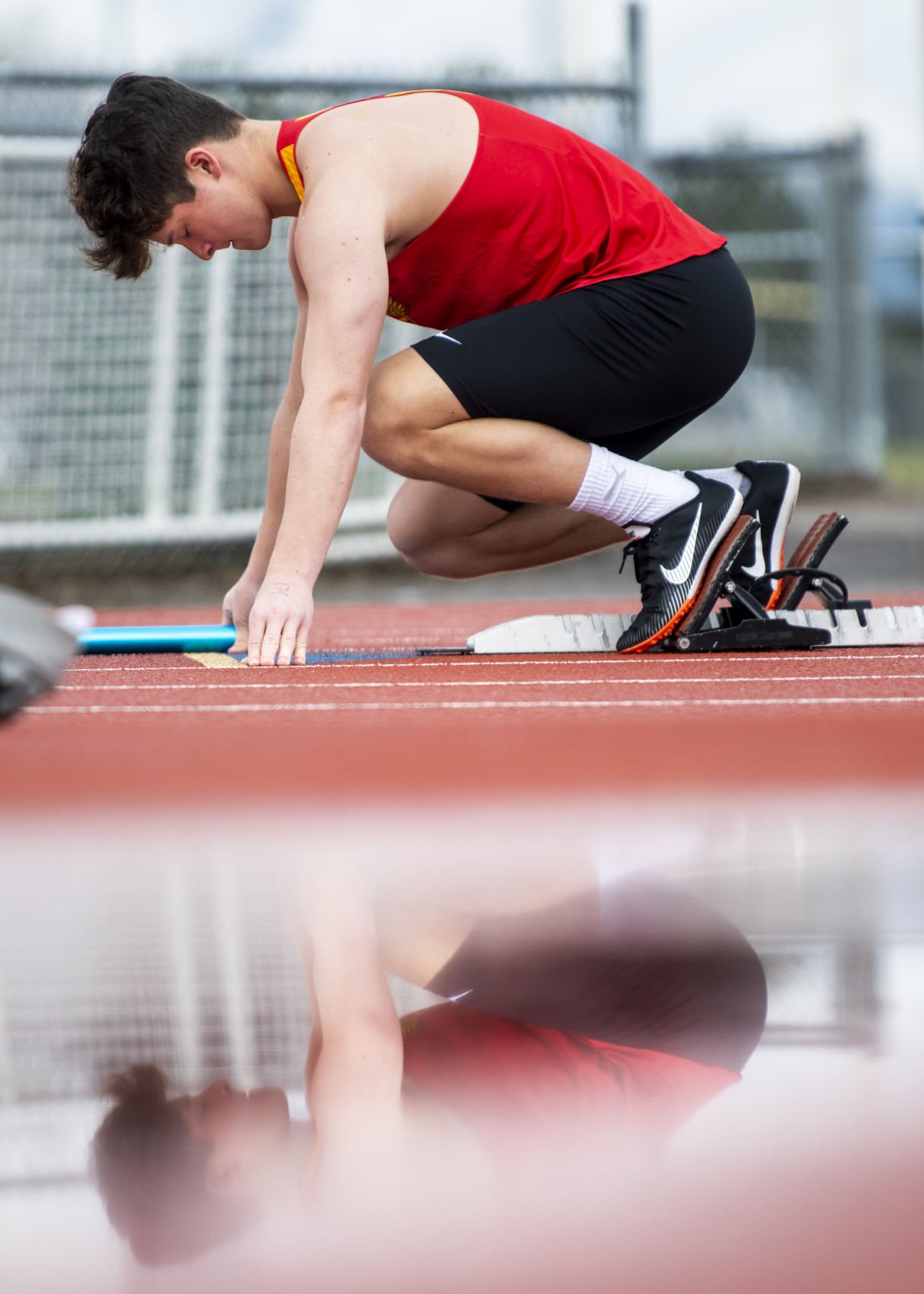  Hellgate's Leo Filardi lines up on the blocks for the boys 4x100 meter dash during the dual track meet between Missoula Hellgate and Kalispell Glacier at Missoula County Stadium on Thursday. 