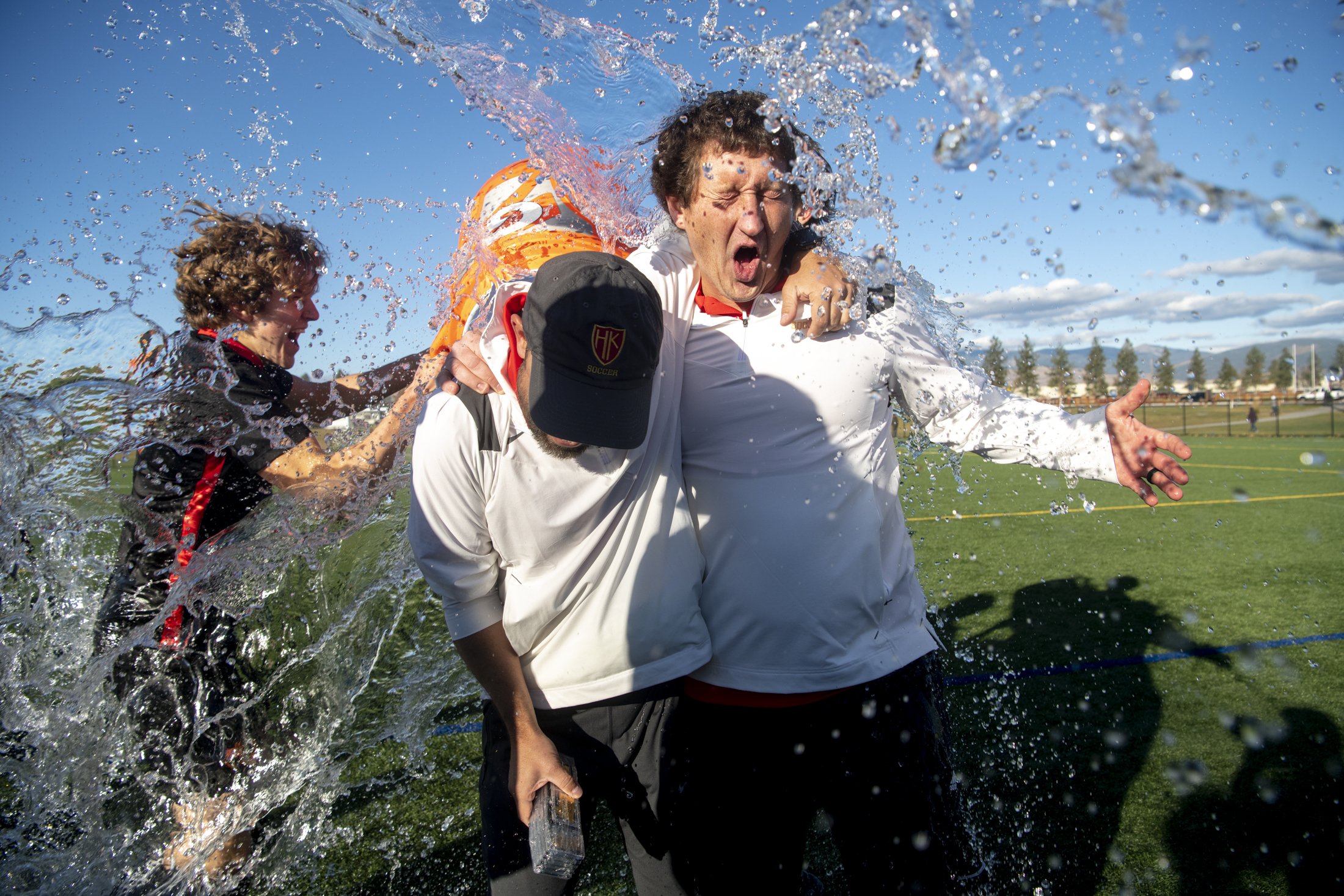  Hellgate’s Lars Thorne-Thomsen drenches the coaches following during the AA soccer state championship match  at Fort Missoula, Saturday, Oct. 30, 2021. The Knights defeated the Wolfpack, 1-0, in overtime to win their third straight title.  