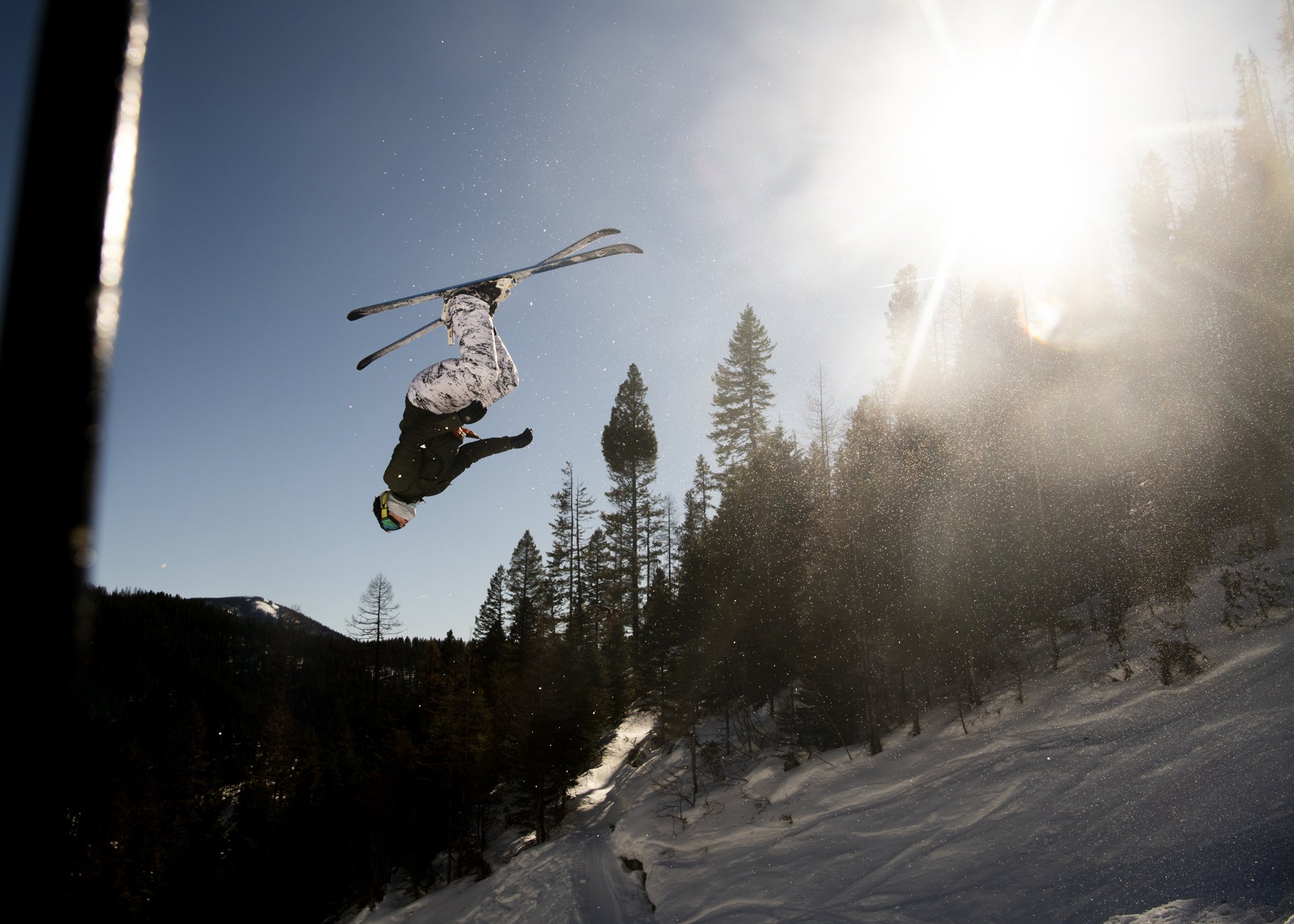  Thomas Stevens, a coach and brother of Olympian Darian Stevens, practices moguls — which includes jumps — at Snowbowl in preparation for the regional competition, Feb. 10, 2022.  