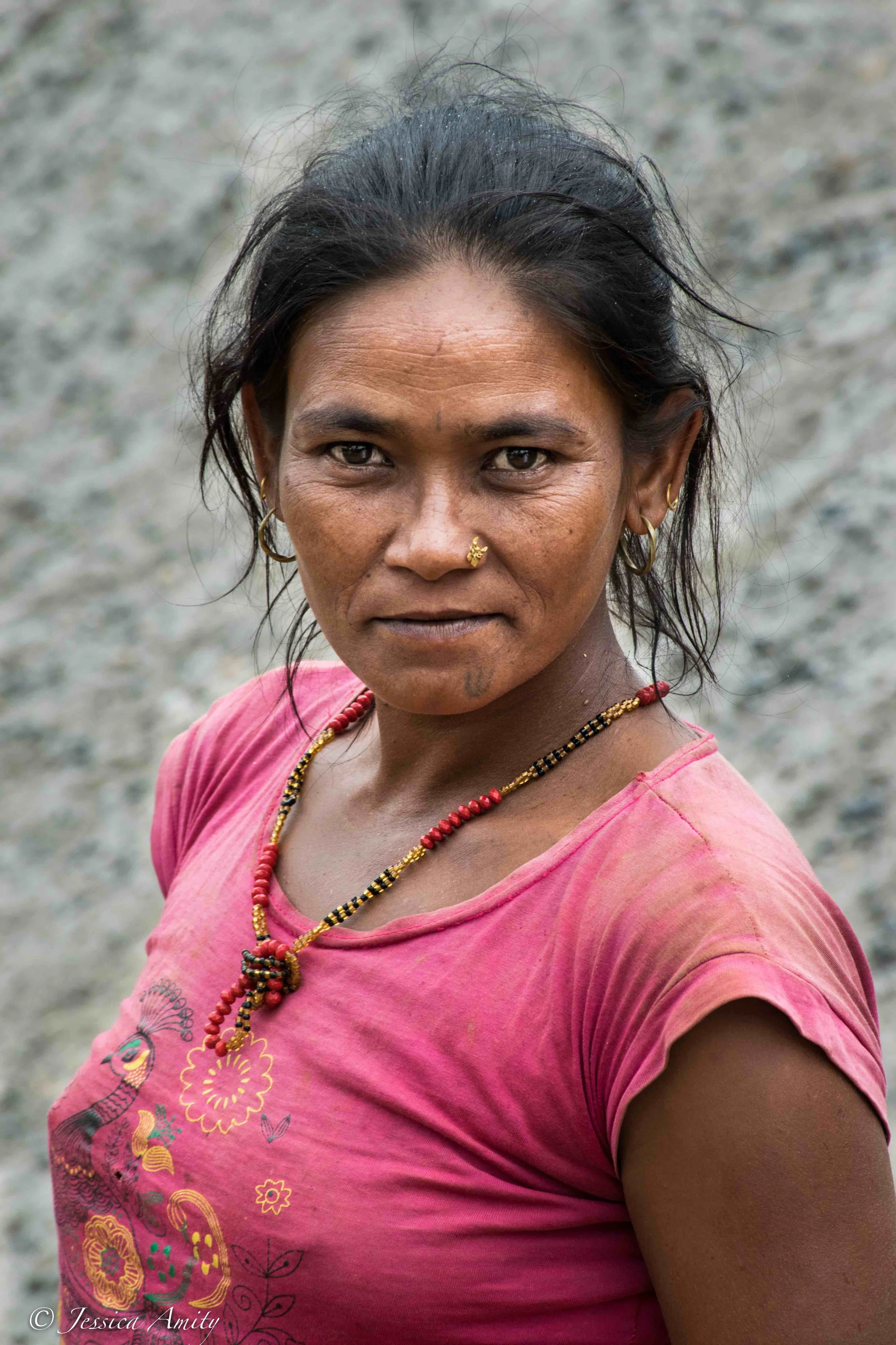Tattoos in Nepalese culture have many different meanings. You’ll notice that this woman has a the symbol of a trident or trishula on her chin. In Hinduism the trishula also has a few different meanings, firstly it is the weapon and emblem of the Lord Shiva, the God of Destruction. It has also come to symbolize several important ‘triads’, for instance creation, preservation and destruction; will, action and wisdom (feminine) as well as desire, will and love.