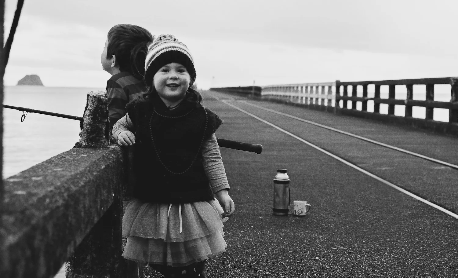 little girl smiling at camera on Tolaga Bay Wharf