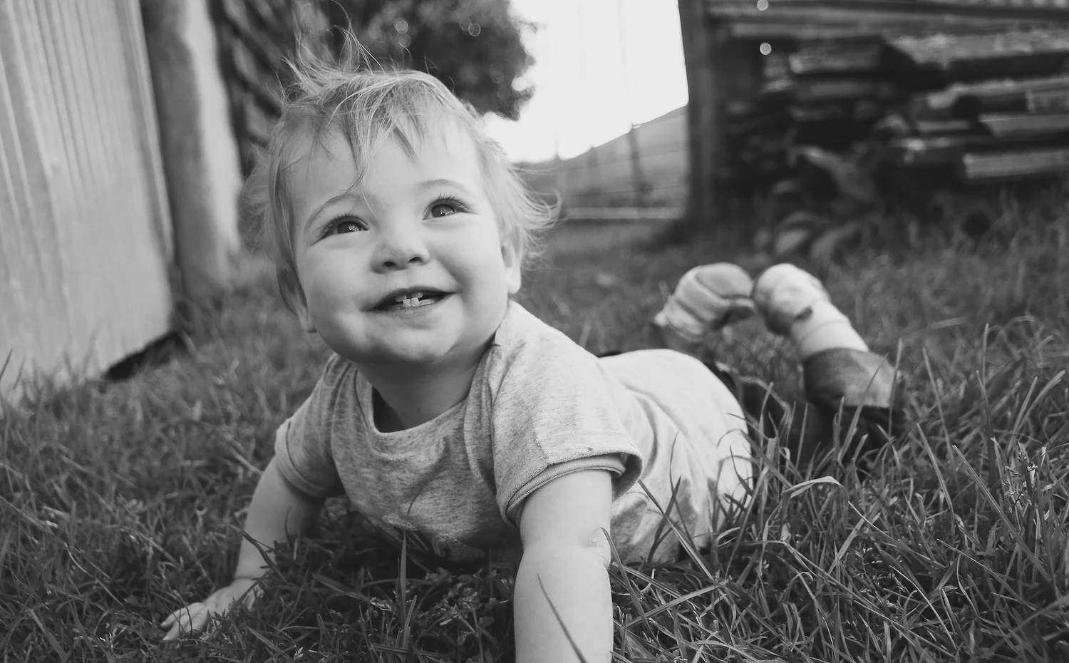 baby girl in grass smiling