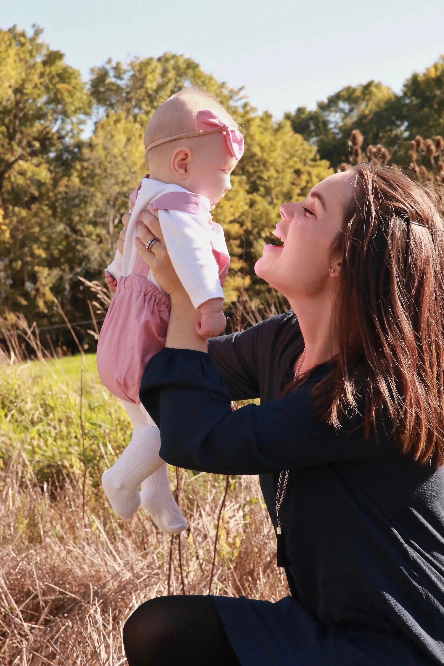 little girl wearing pink with mum on farm