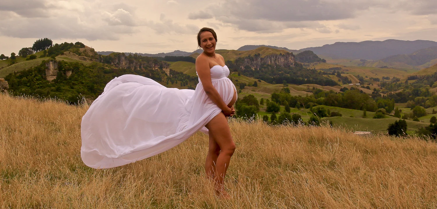 pregnant girl on farm wind in dress