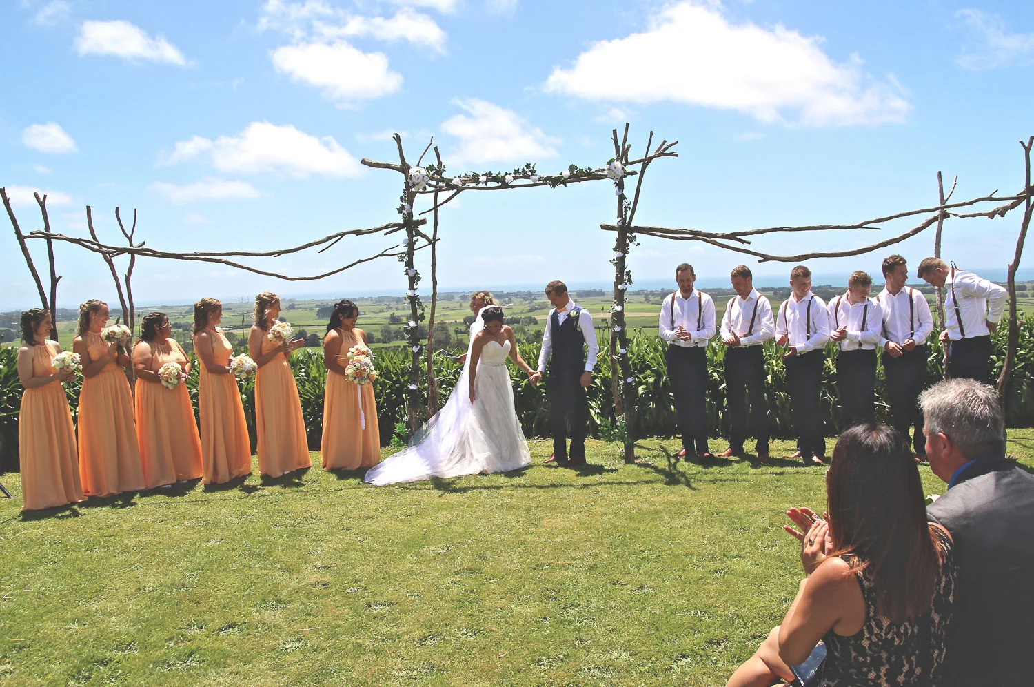 bride_and_groom_on_wedding_day_ceremony_stunning_view_standing_under_achway.jpg