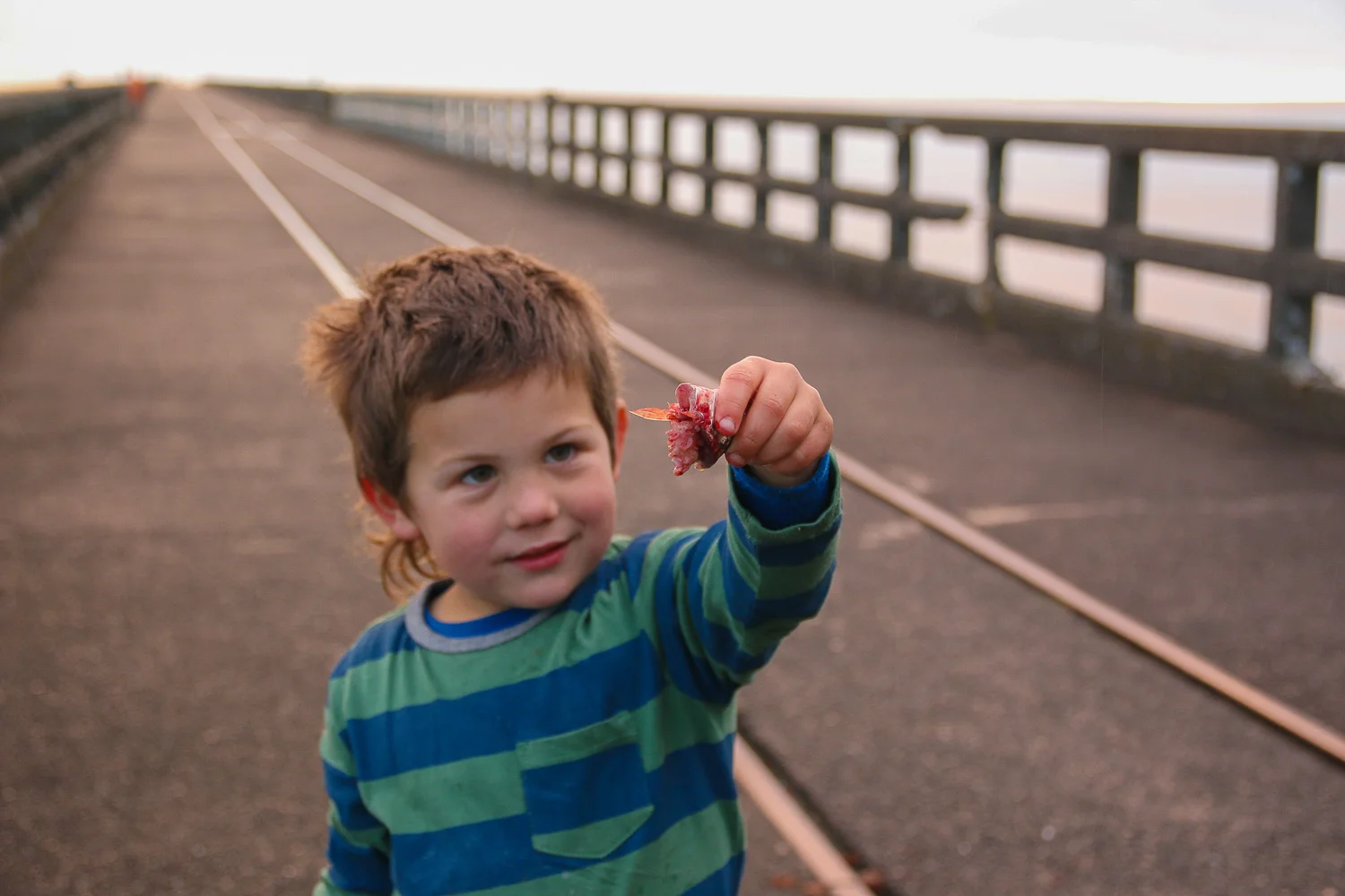little-boy-winter-sunrise-gutting-a-fish-close-up.jpg