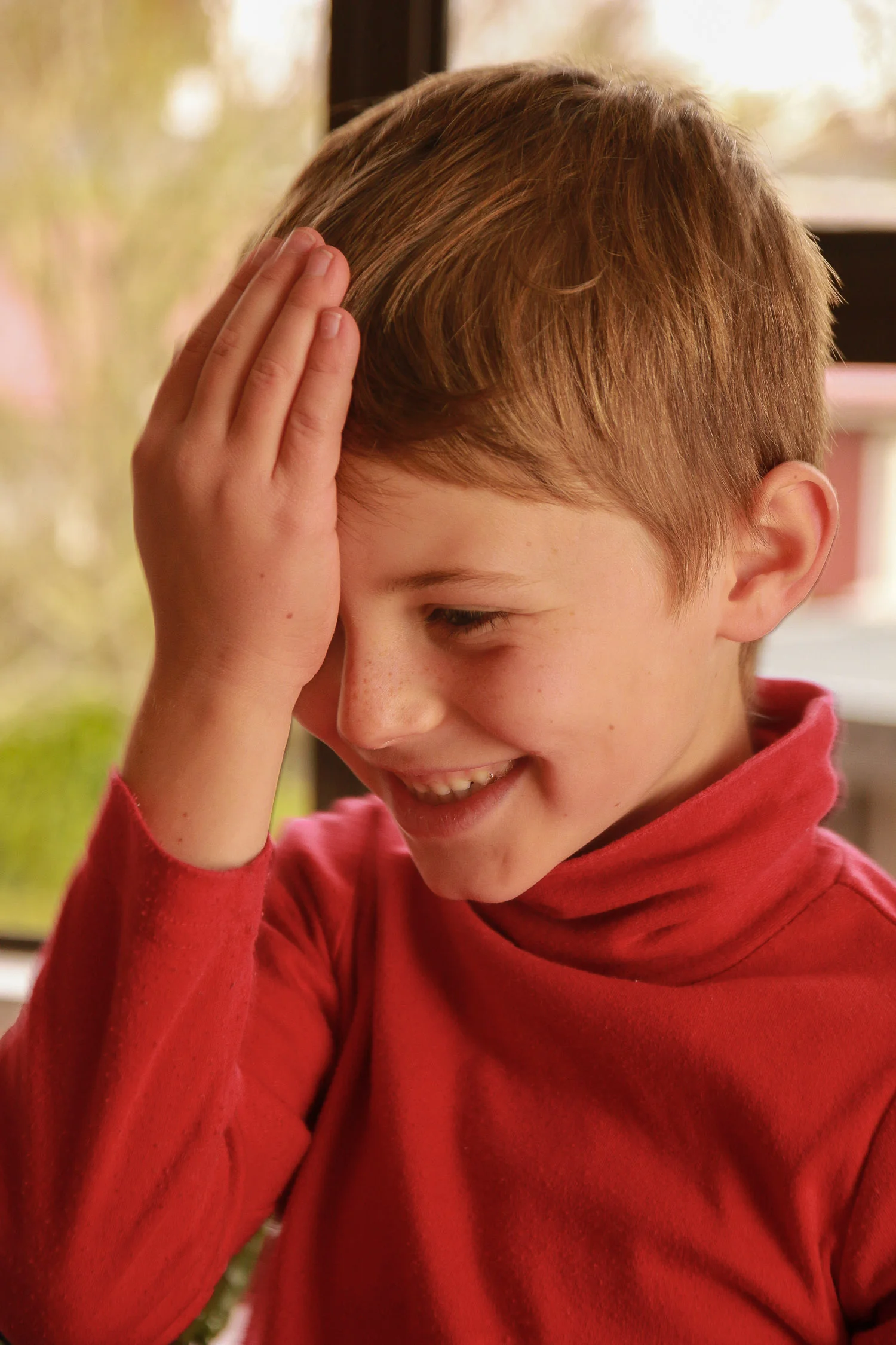little-boy-wearing-red-playing-with-something-in-his-hair.jpg