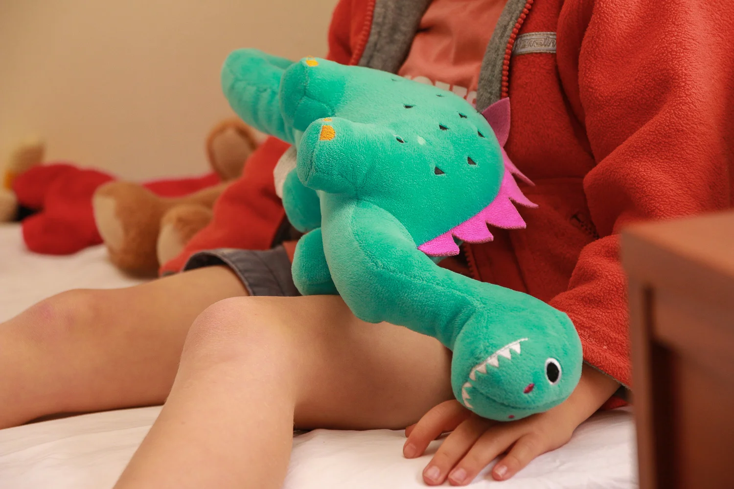 little-boy-wearing-red-holding-dinosaur-toy.jpg