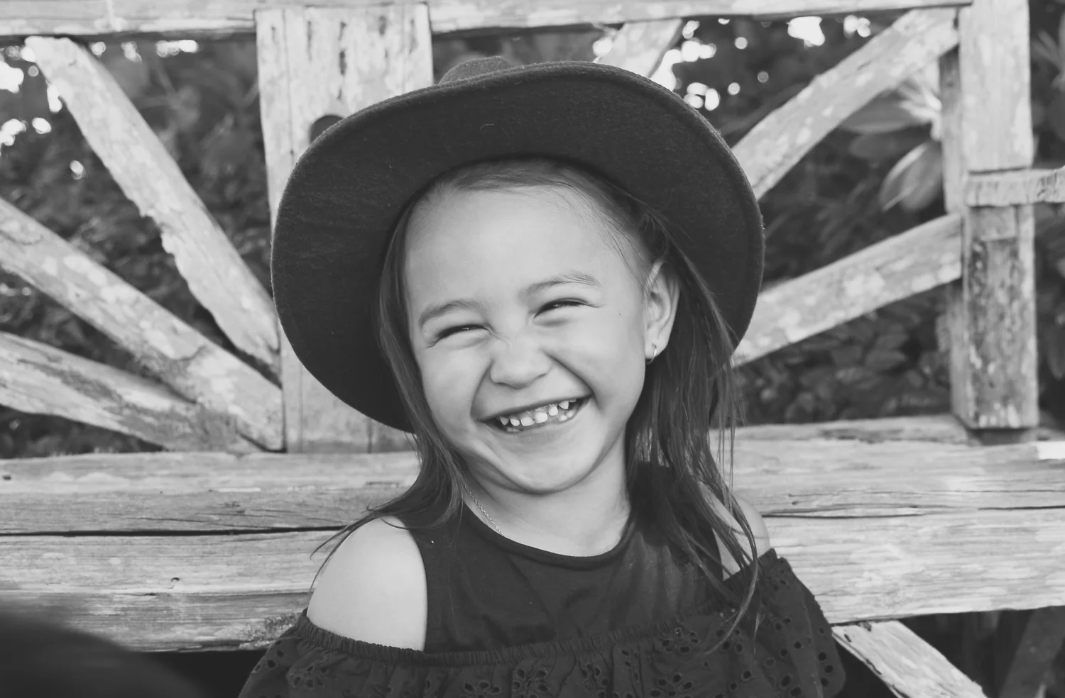 black-and-white-image-of-girl-laughing-wearing-cool-hat-laughing_L-R.jpg