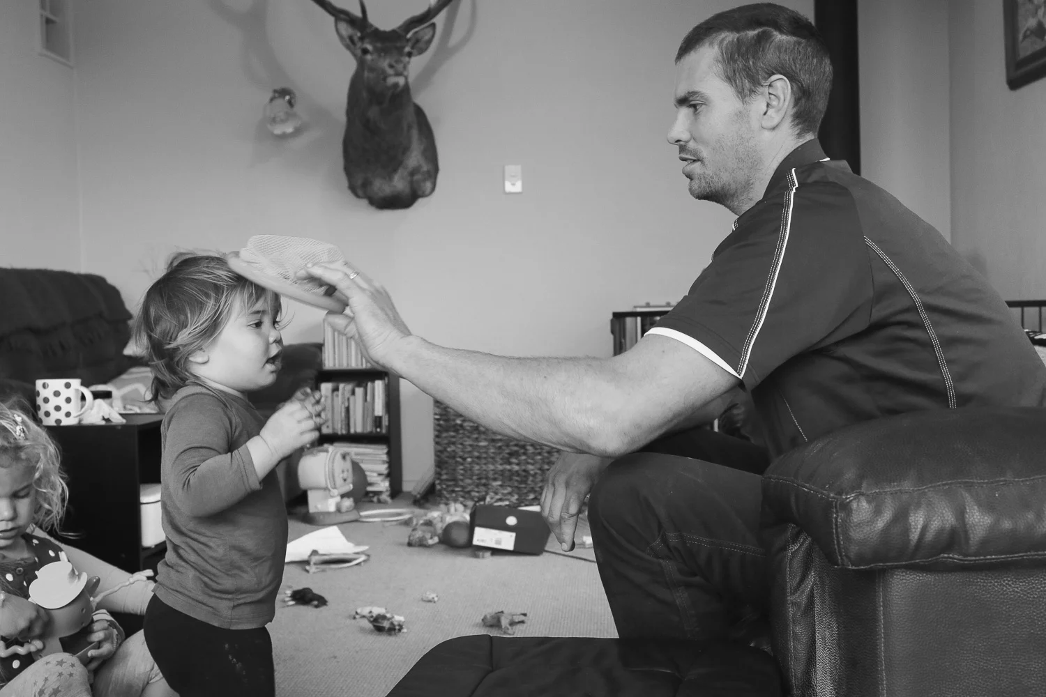 rowland-smith-shearer-playing-with-daughter-at-home-in-lounge.jpg