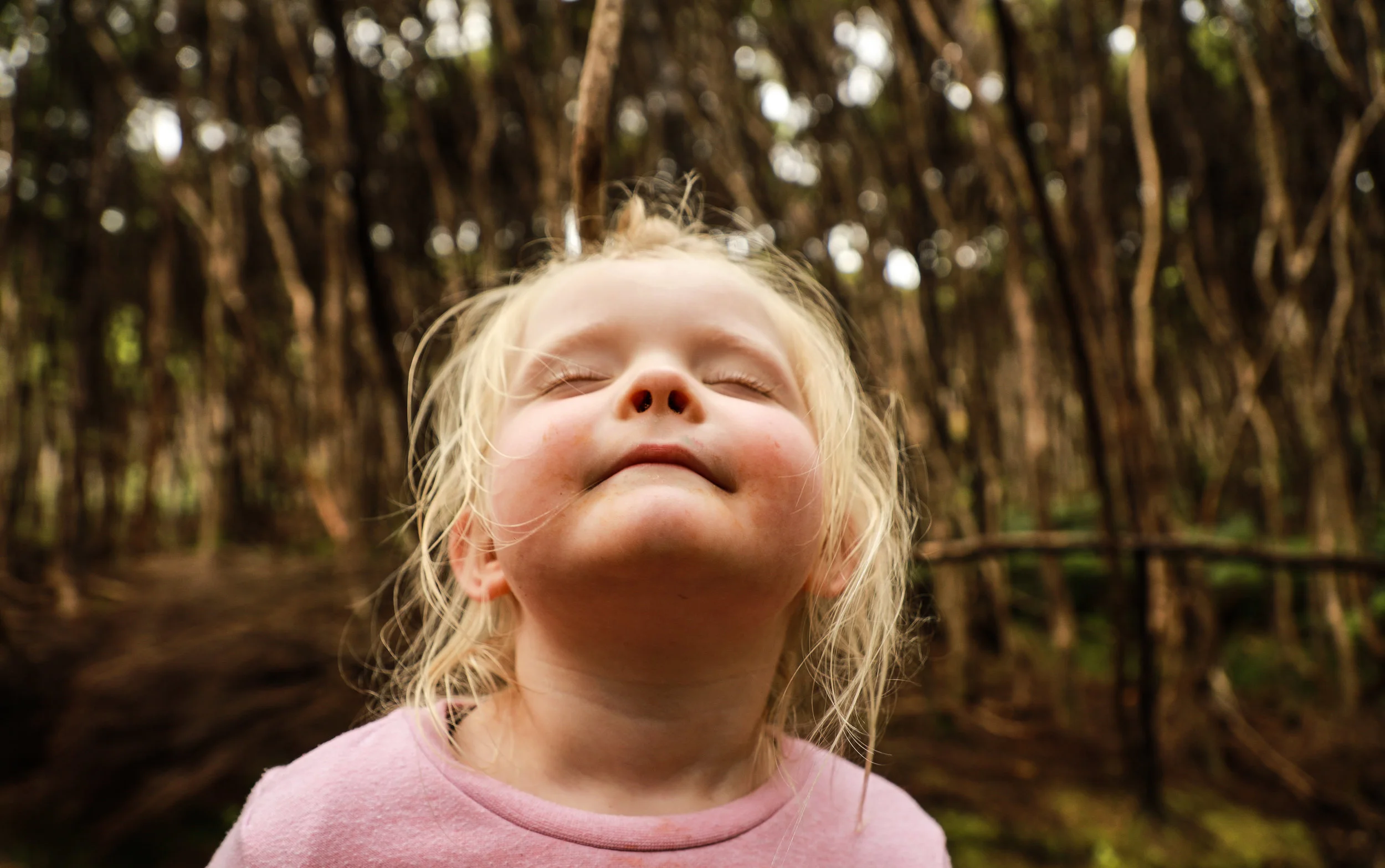 little-girl-eyes-closed-in-forest-taking-deep-breath.jpg