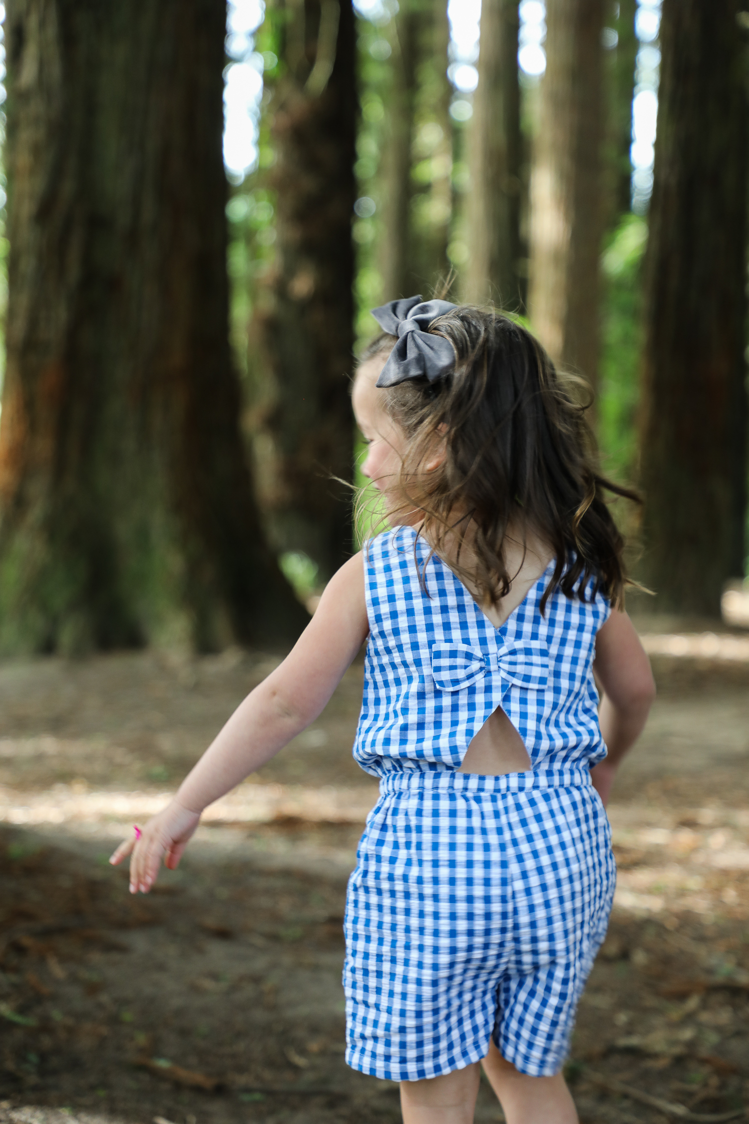 little girl playing in the forest