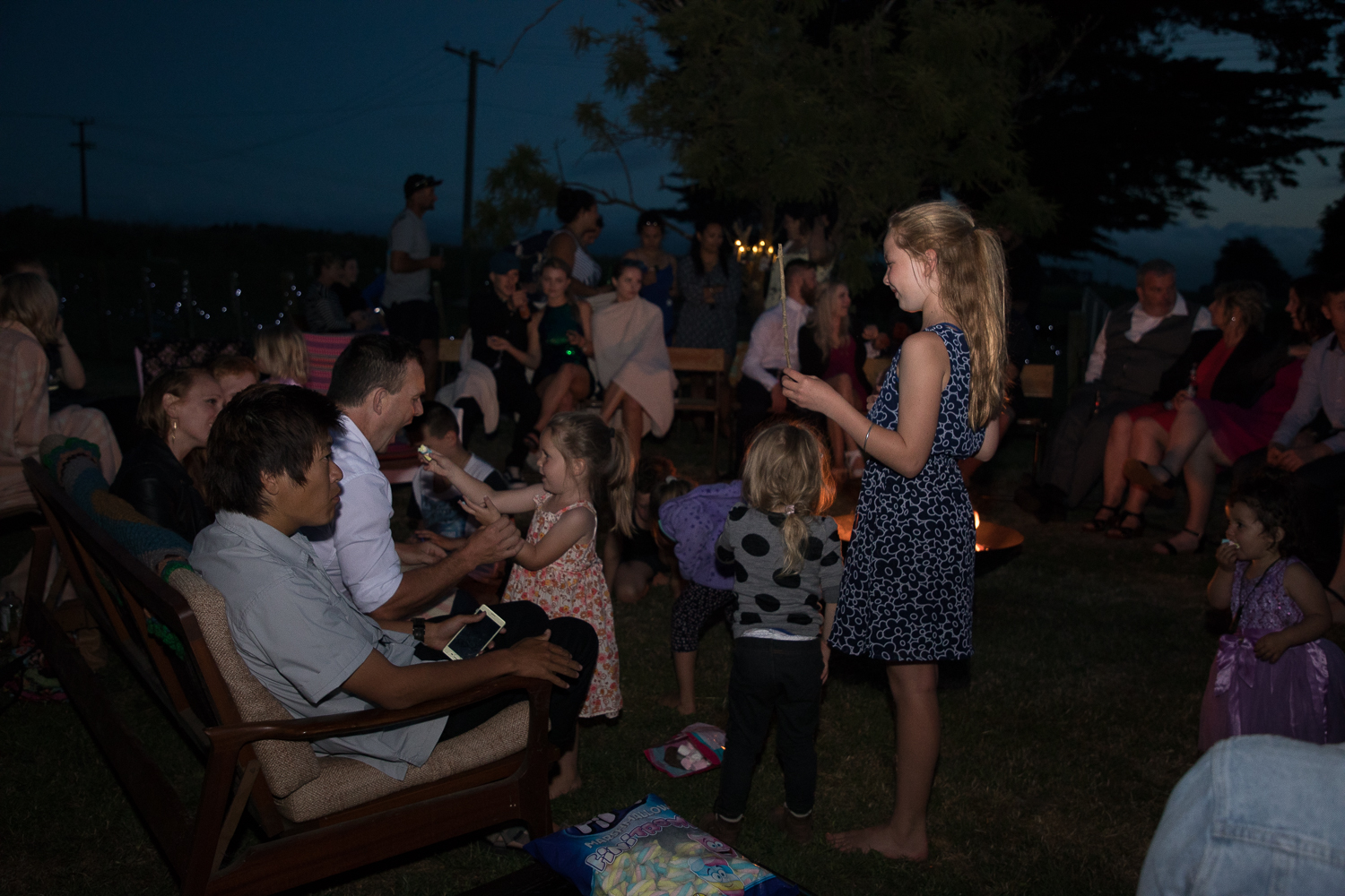 wedding-photography-guests-sitting-around-fire.jpg