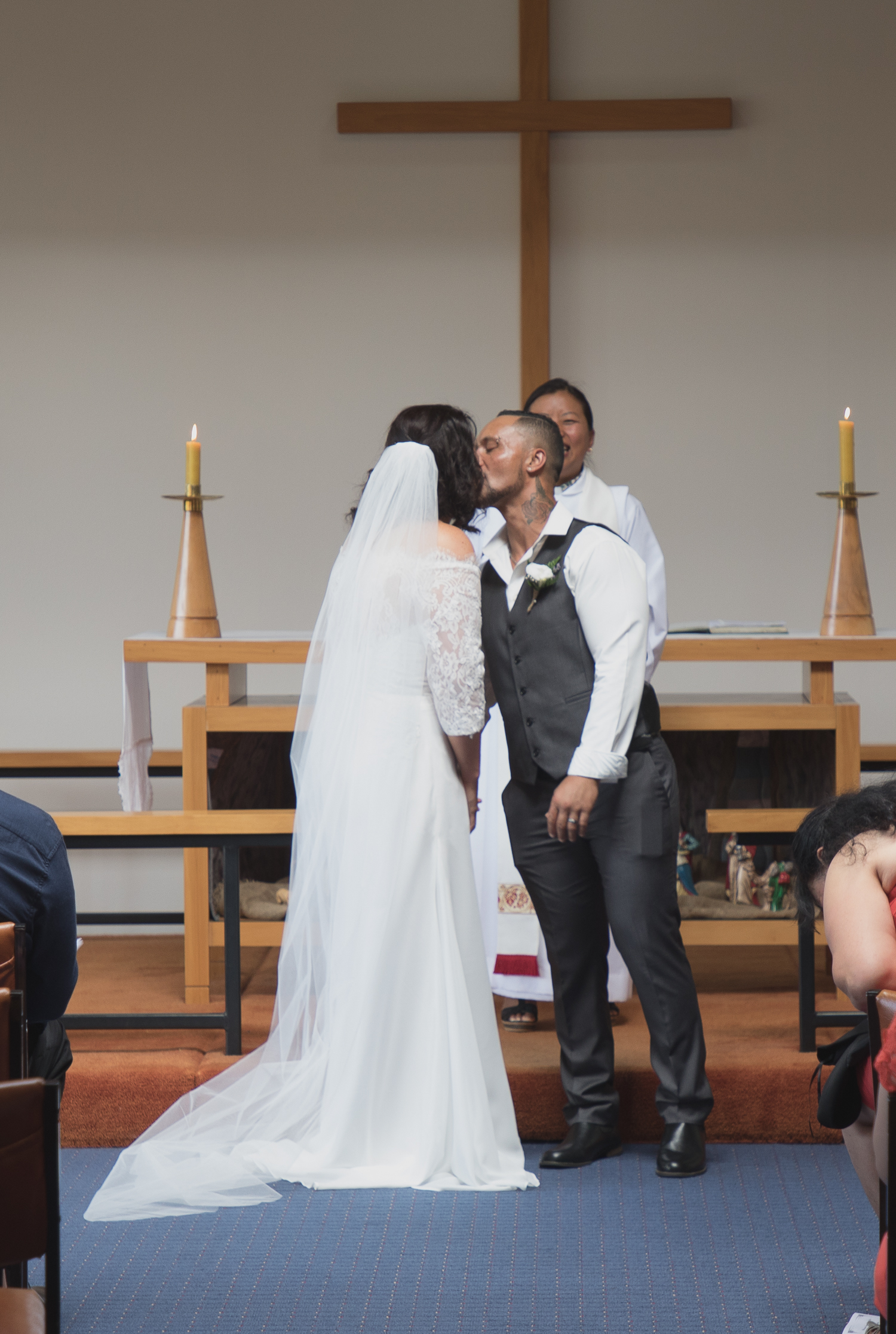 bride and groom first kiss during wedding ceremony