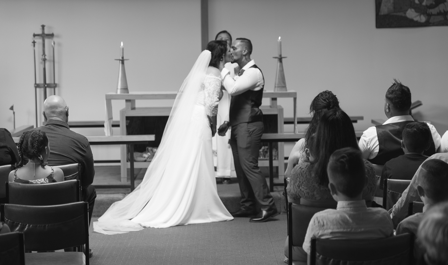 bride and groom kiss during wedding ceremony