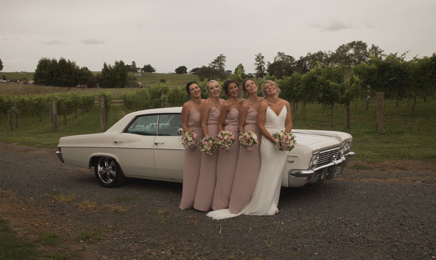 bride and bridesmaid with wedding car
