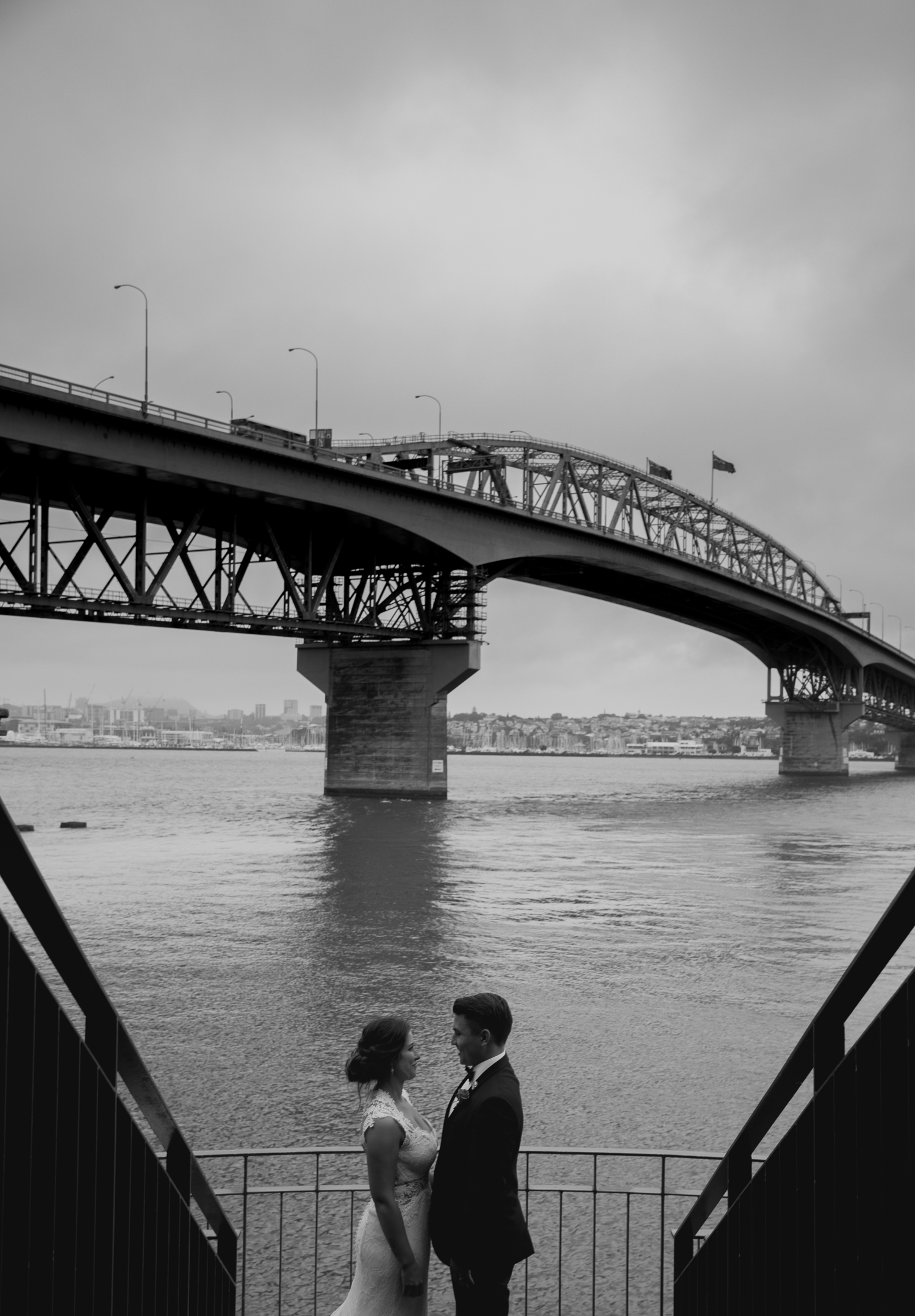 bride and groom underneath the Auckland Harbour Bridge