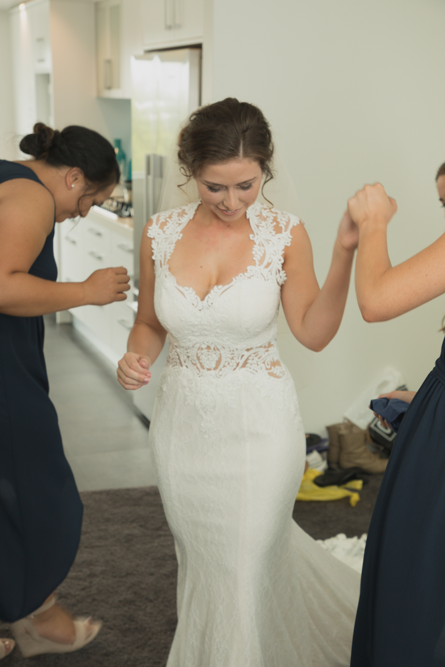 bride-showing-bridesmiads-dress-for-first-time.jpg