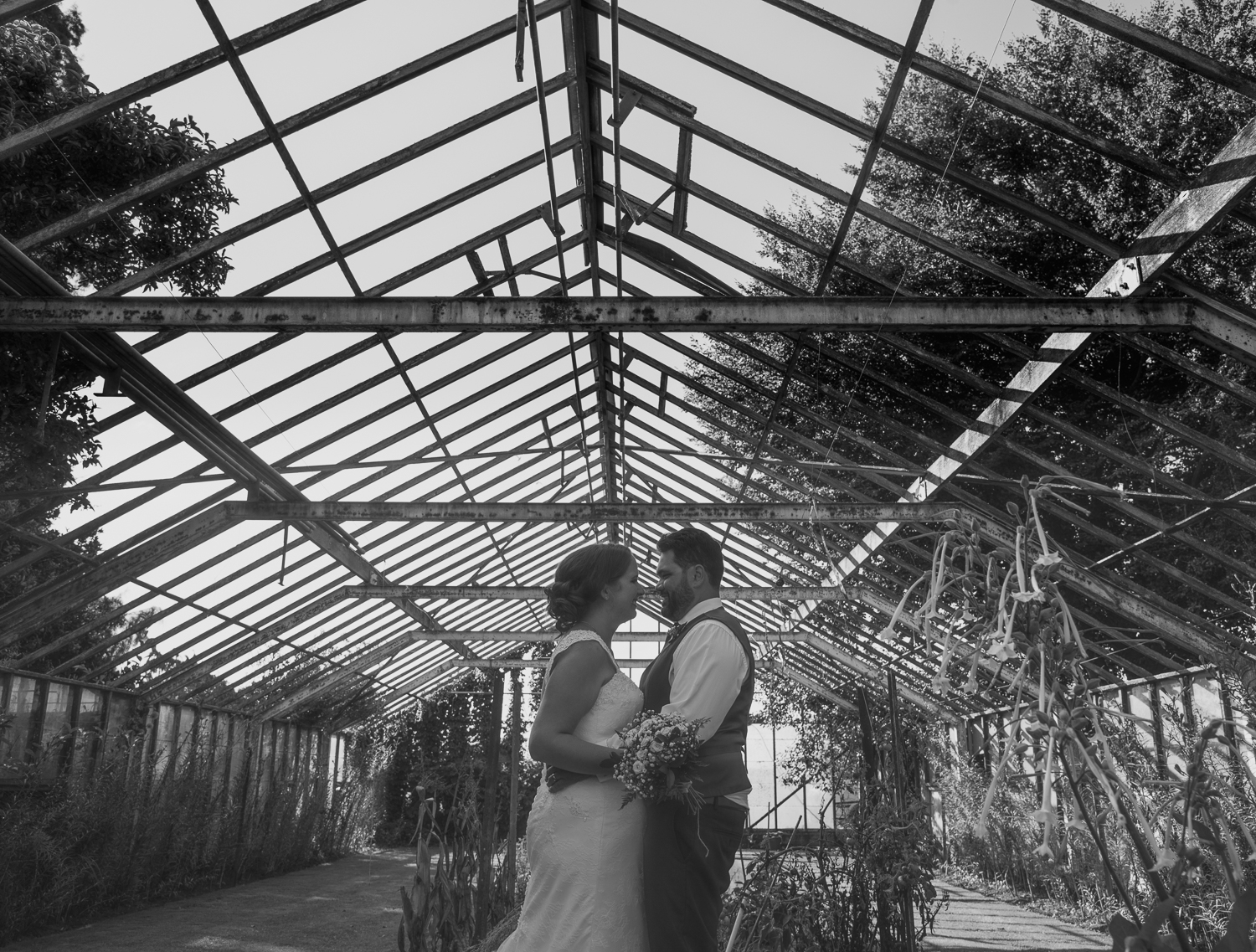 bride and groom in abandoned glasshouse on wedding day