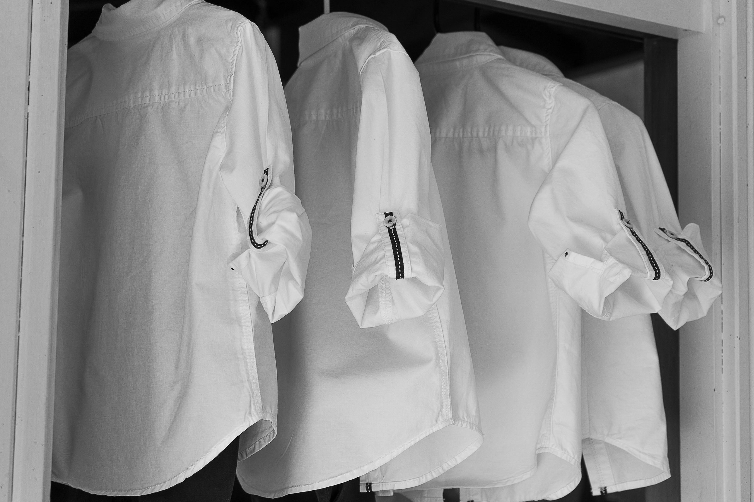 groomsmen's shirts hanging up ready for wedding