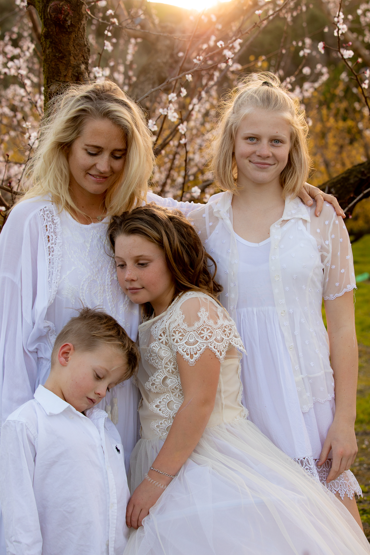 family in pink blossoms spring time