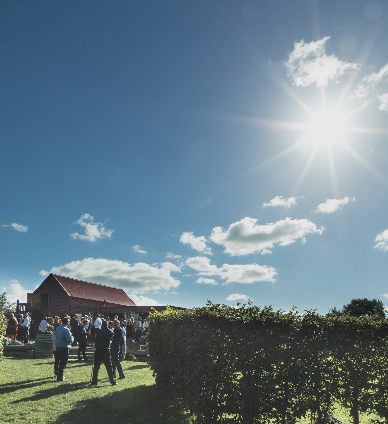 wedding-at-the-red-barn-new-zealand-wedding-photographer-sun-over-red-buildings.jpg